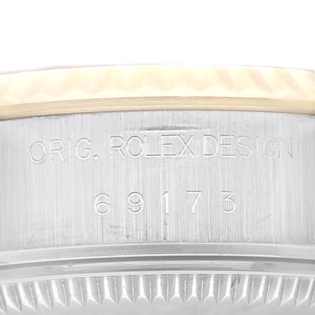 The image shows a close-up of the side of a Rolex Datejust 69173 Women's Steel and Gold (two tone) Champagne Dial 69173 Women's Steel and Gold (two tone) Champagne Dial watch, highlighting the model number and "ORIG. ROLEX DESIGN" engraving.