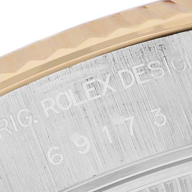 The image shows a close-up of the bezel and the engraved case back of a Rolex Datejust 69173 Women's Steel and Gold (two tone) Mother of Pearl Dial 69173 Women's Steel and Gold (two tone) Mother of Pearl Dial watch.