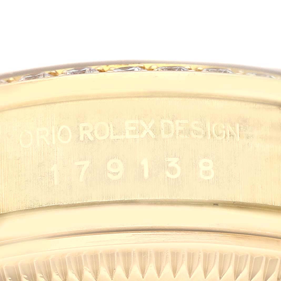 This image shows a close-up of the side of a Rolex President 179138 Women's Yellow Gold Black Dial 179138 Women's Yellow Gold Black Dial model watch, featuring the model number and "Rolex Design" engraving.