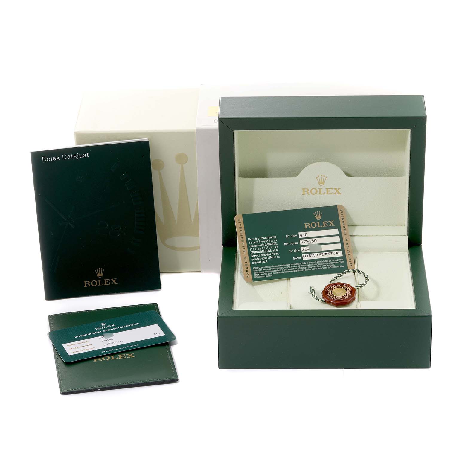 This image shows the packaging, warranty card, booklet, and accessories for a Rolex Datejust 179160 Women's Stainless Steel Pink Dial 179160 Women's Stainless Steel Pink Dial watch.
