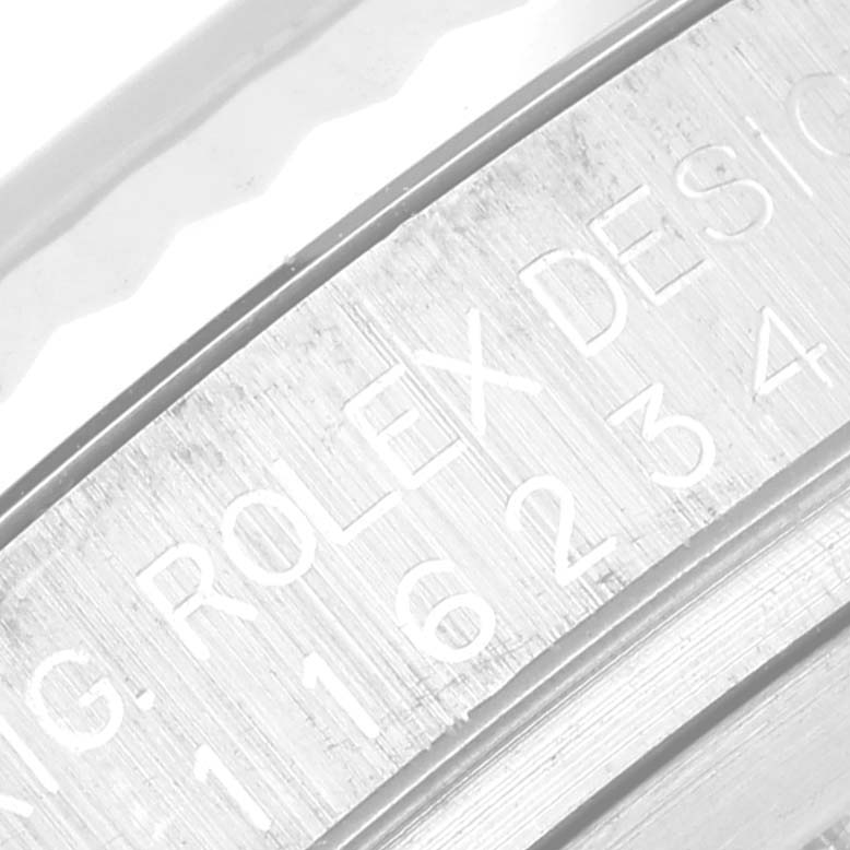 This image shows an angled close-up of the inner case of a Rolex Datejust 116234 Men's Stainless Steel Black Dial 116234 Men's Stainless Steel Black Dial watch with "ROLEX" engraving visible.