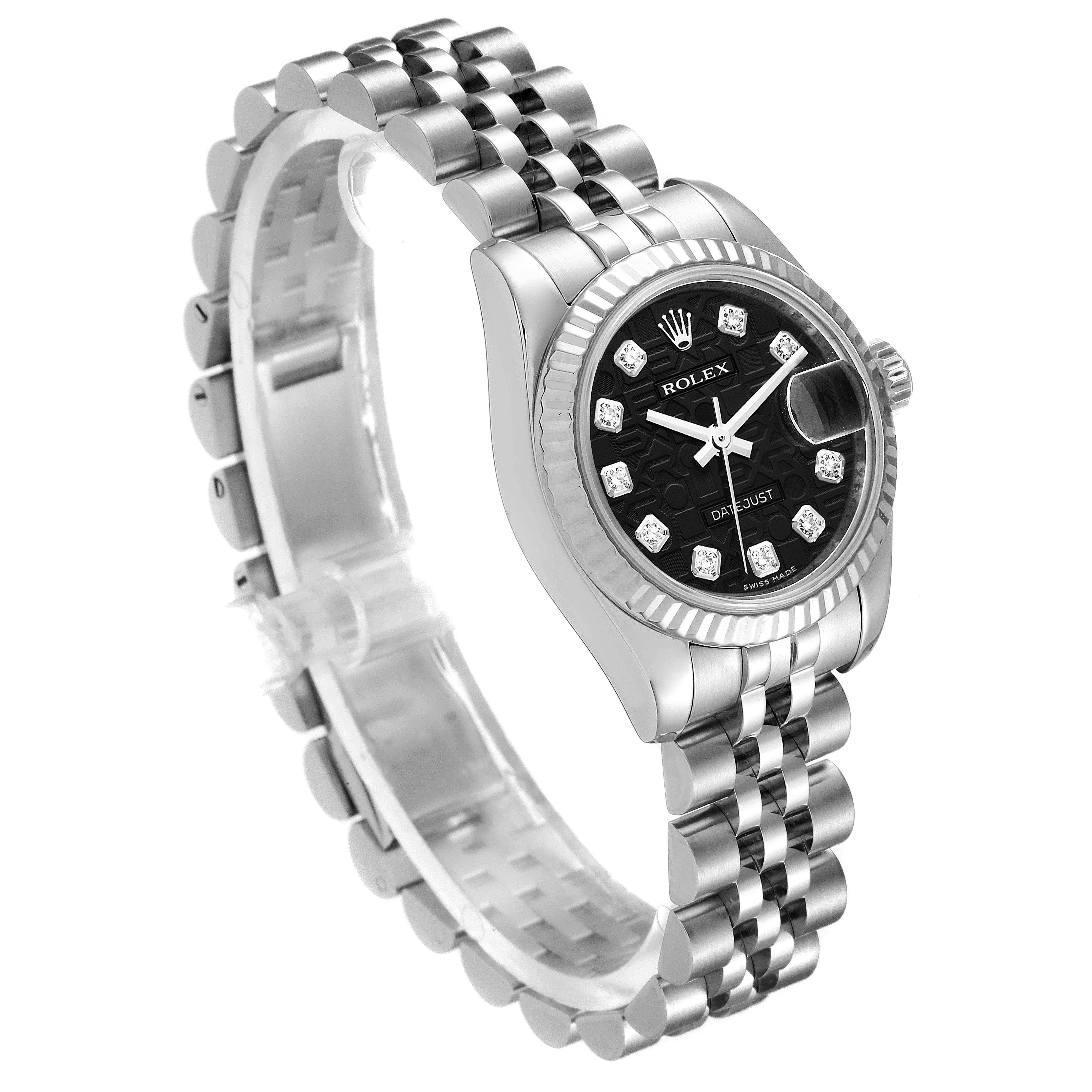 The image shows a Rolex Datejust 179174 Women's Stainless Steel Black Dial 179174 Women's Stainless Steel Black Dial watch angled to display its face, fluted bezel, and Jubilee bracelet.