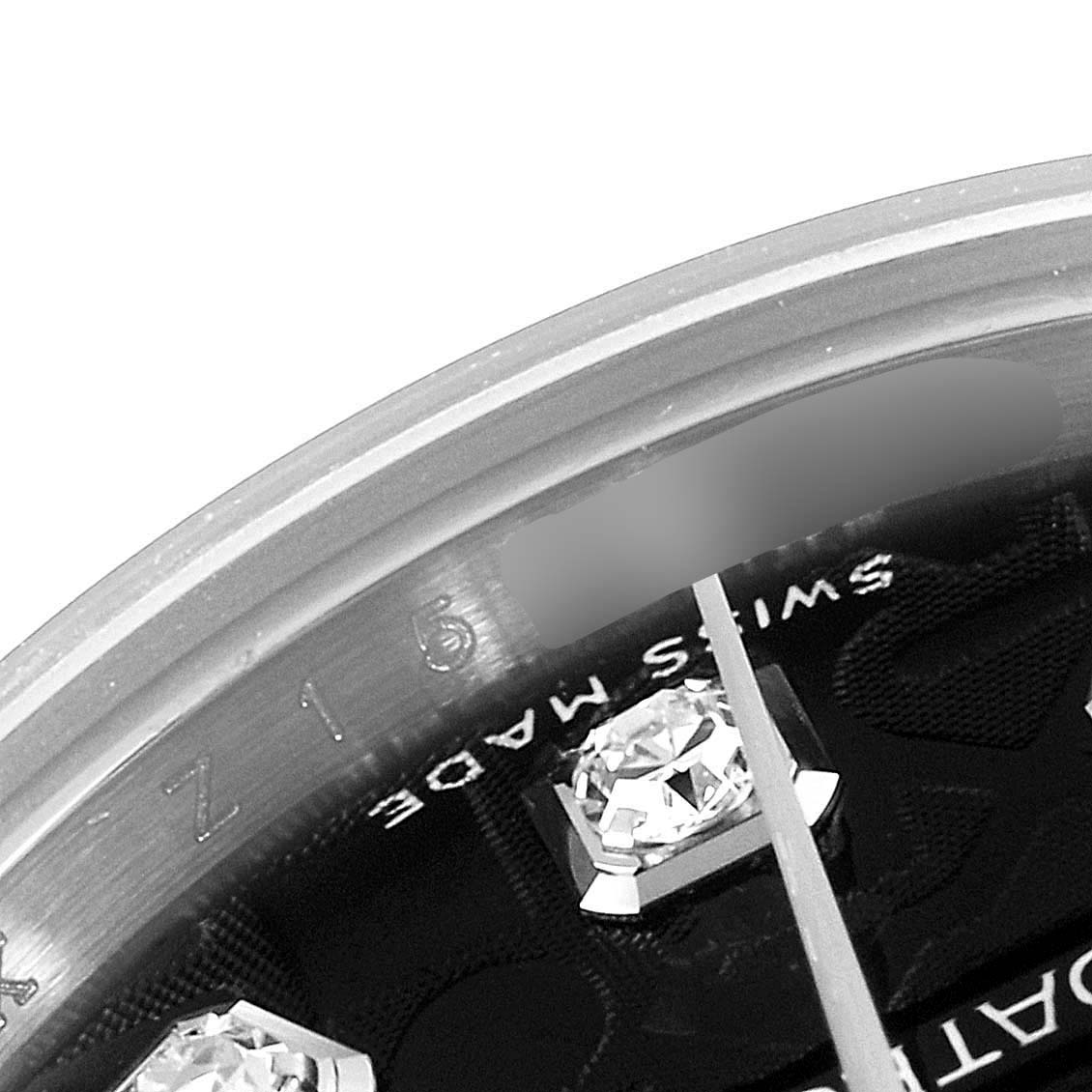 This is a close-up image of the dial and crystal edge of the Rolex Datejust 179174 Women's Stainless Steel Black Dial 179174 Women's Stainless Steel Black Dial watch, showing diamonds and parts of the text.