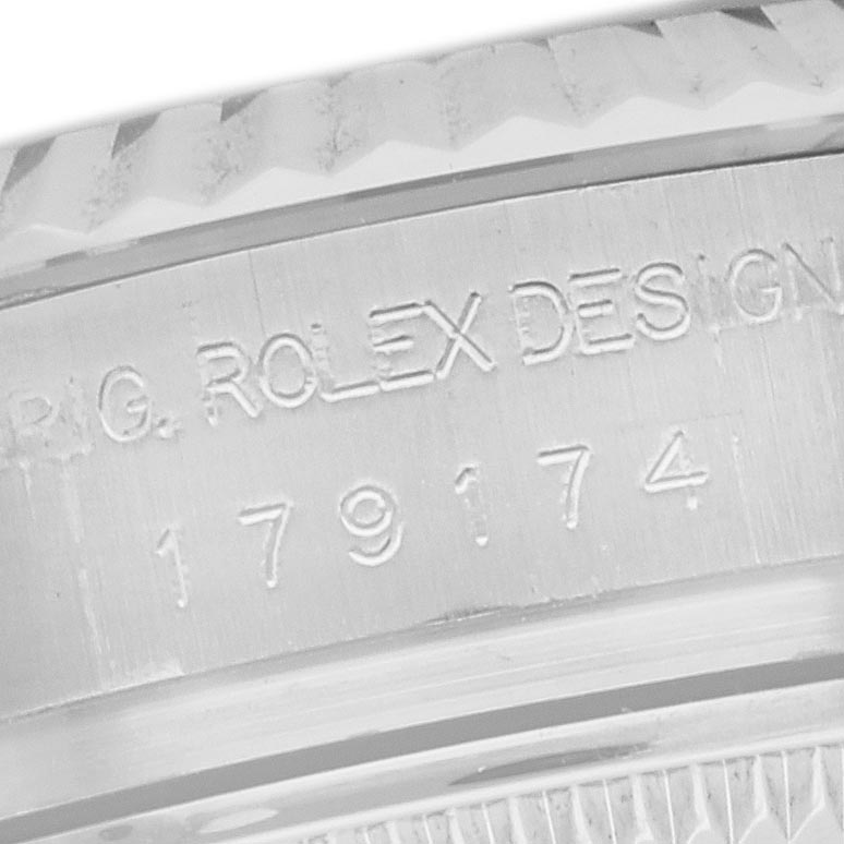 The image shows an angled close-up of the serial engraving on the Rolex Datejust 179174 Women's Stainless Steel Mother of Pearl Dial 179174 Women's Stainless Steel Mother of Pearl Dial watch case.