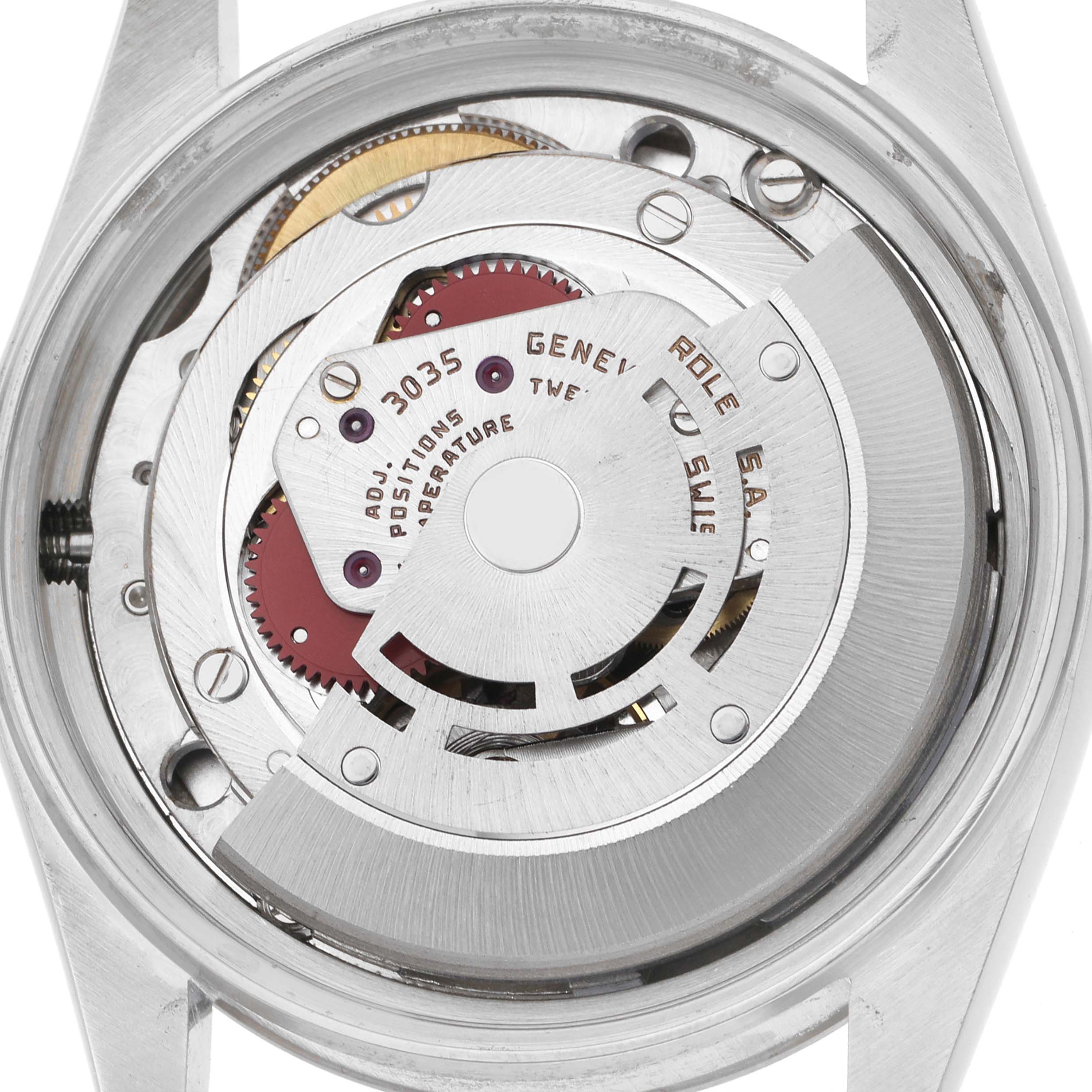 The image shows the movement of a Rolex Datejust 16014 Men's Stainless Steel Silver Dial 16014 Men's Stainless Steel Silver Dial from the back, revealing gears and components.