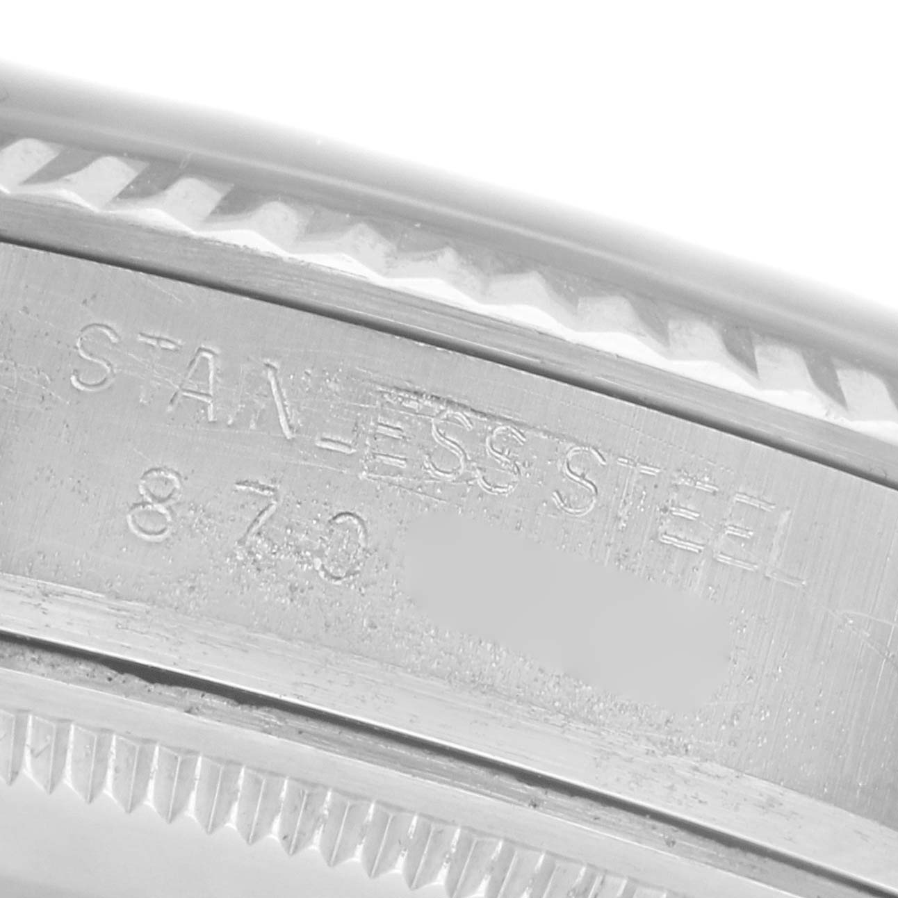 The image shows a close-up angle of the Rolex Datejust 16014 Men's Stainless Steel Silver Dial 16014 Men's Stainless Steel Silver Dial model's case side, featuring engravings on the stainless steel material.