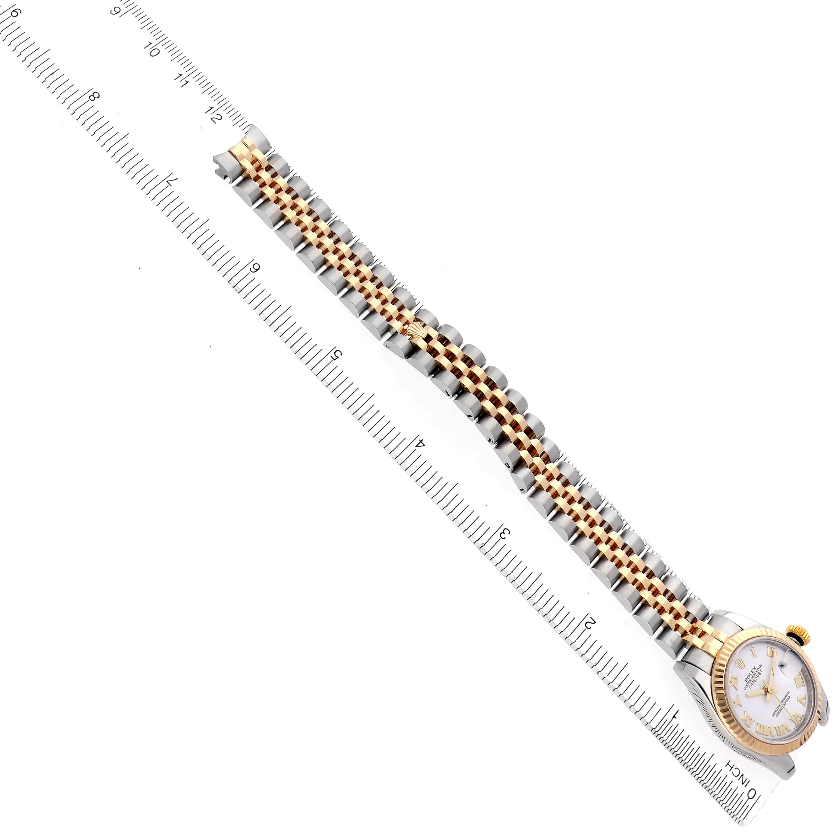 The Rolex Datejust 179173 Women's Steel and Gold (two tone) White Dial 179173 Women's Steel and Gold (two tone) White Dial watch is shown from a top view, displaying the full length of the bracelet and the watch face next to a ruler.