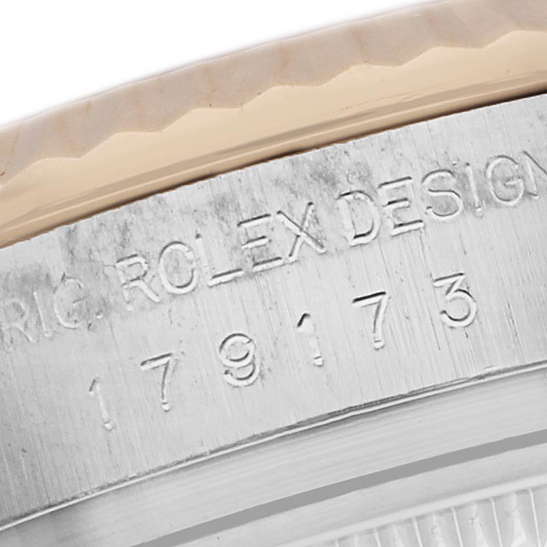 The image shows a close-up of the serial engraving on the side of a Rolex Datejust 179173 Women's Steel and Gold (two tone) White Dial 179173 Women's Steel and Gold (two tone) White Dial watch case.