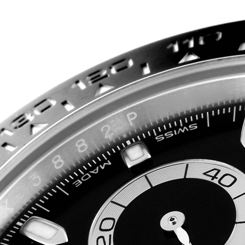 The image shows a close-up of the dial and bezel of the Rolex Daytona 116500 Men's Stainless Steel Black Dial 116500 Men's Stainless Steel Black Dial watch at an angle.