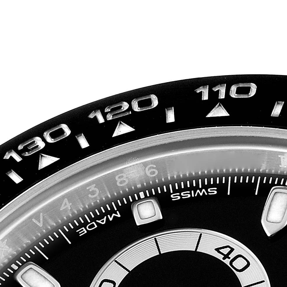 The image shows a close-up of the bezel and partial dial of a Rolex Daytona 116500 Men's Stainless Steel Black Dial 116500 Men's Stainless Steel Black Dial watch.
