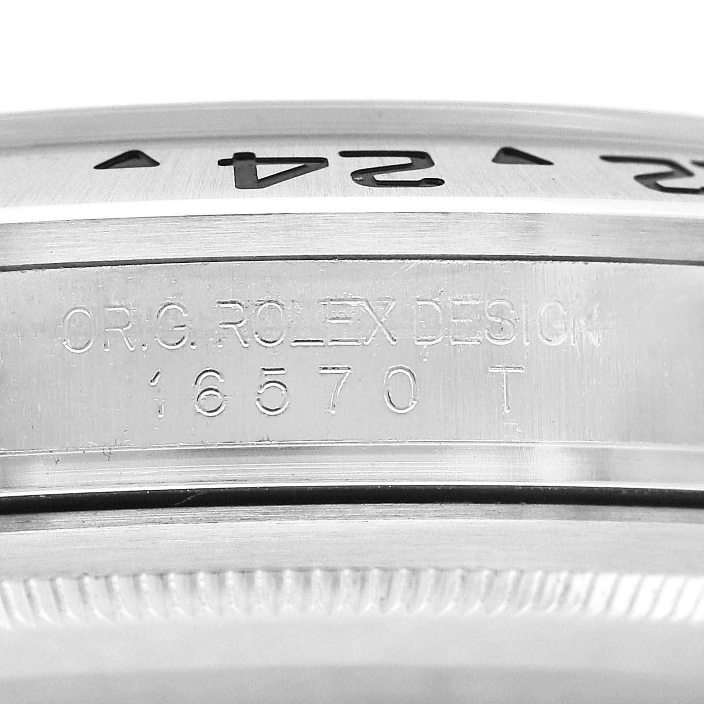 The image shows a close-up of the case side and bezel of a Rolex Explorer 16570 T Men's Stainless Steel White Dial, model number 16570, highlighting engravings.