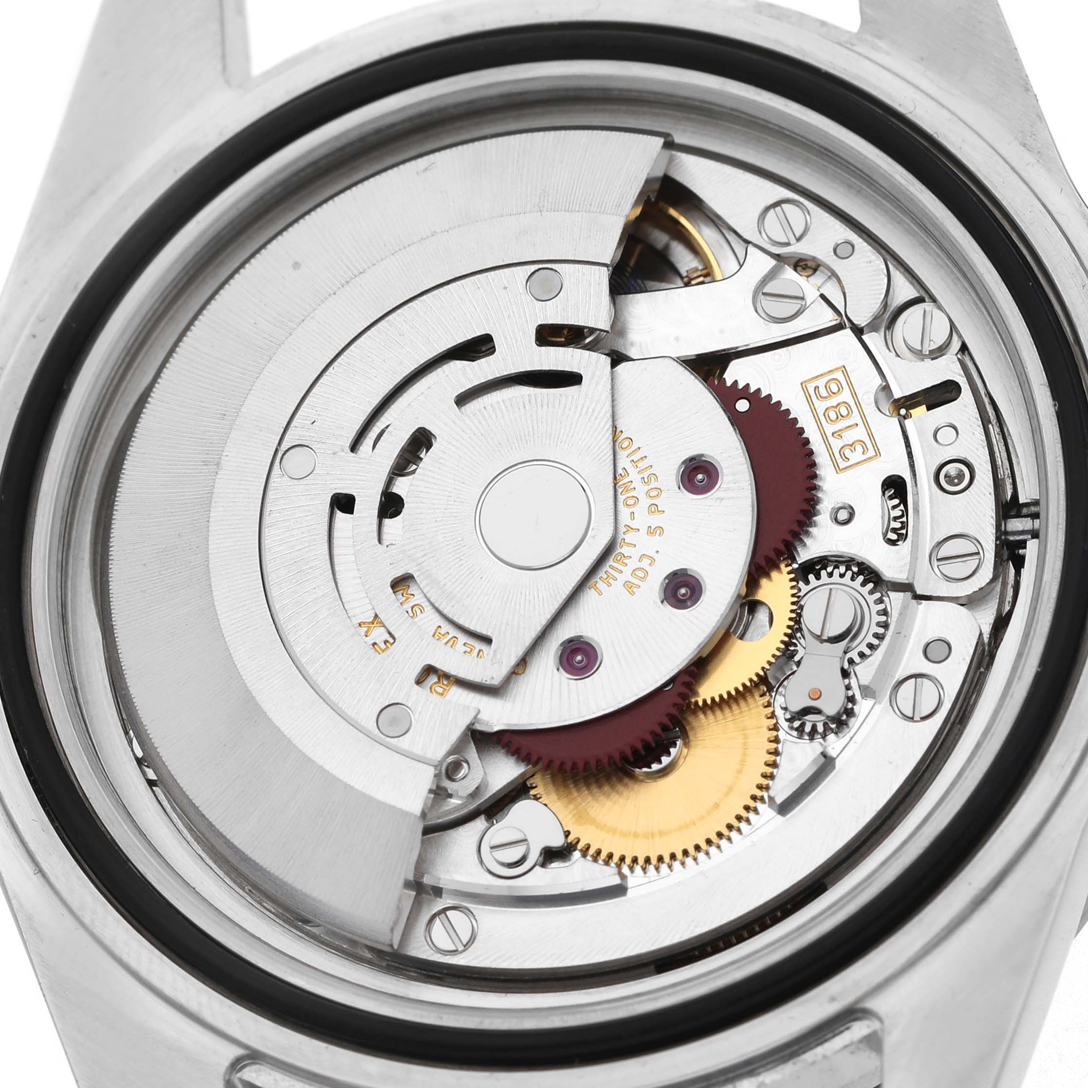 The image shows the Rolex Explorer 16570 T Men's Stainless Steel White Dial watch's movement from a top-down angle, revealing its intricate gears and rotor.