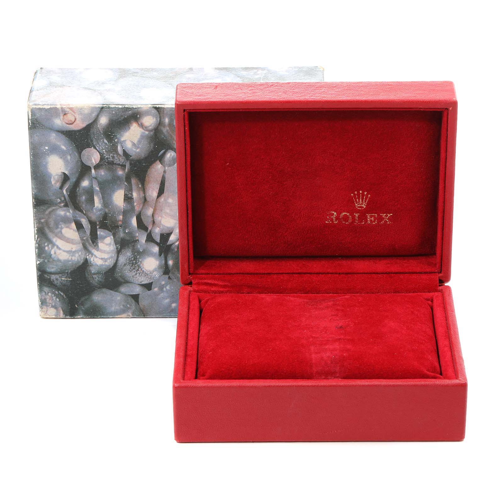 A red velvet Rolex watch box for the Oyster Perpetual model is shown from the front, with the lid open.