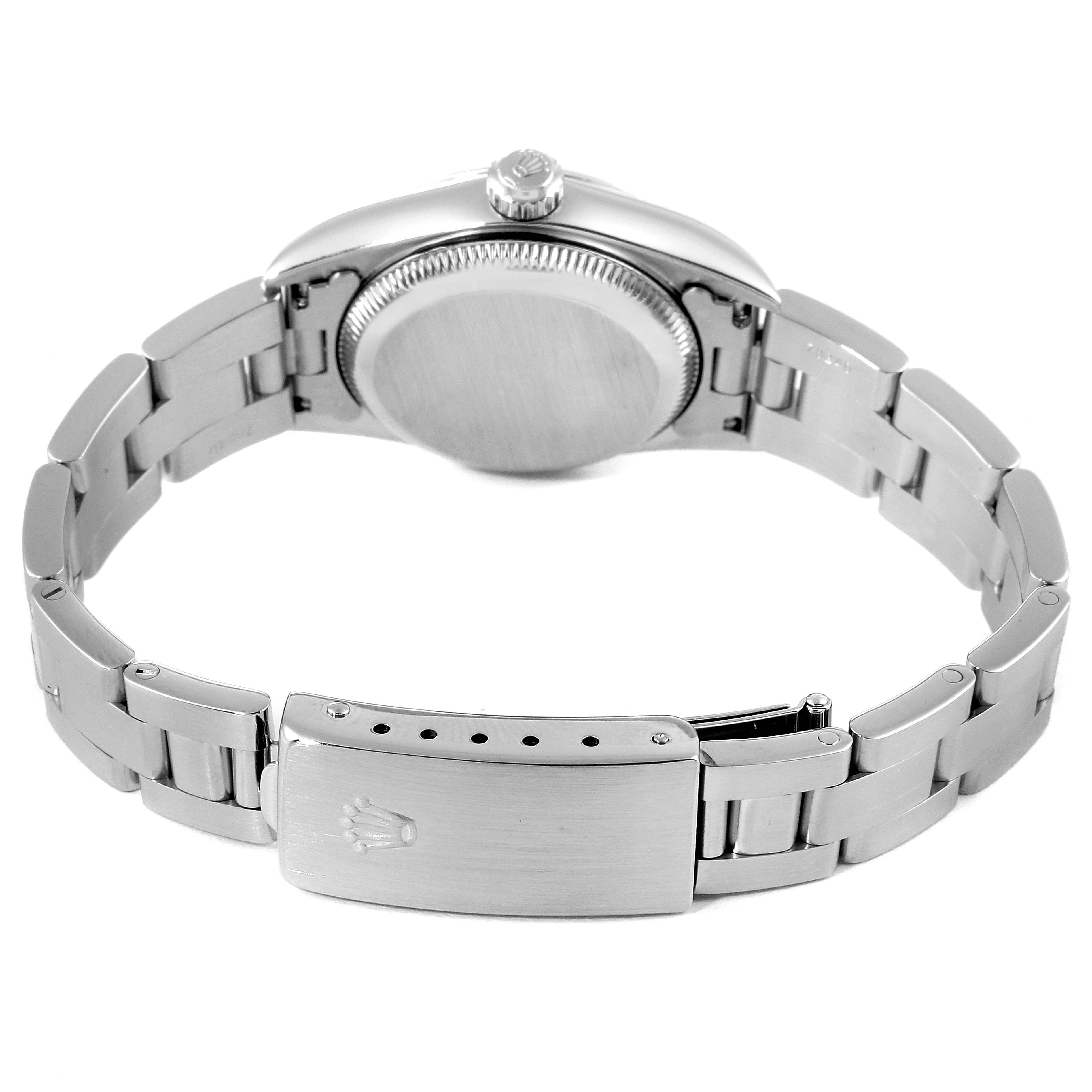 The image shows the back view of a Rolex Oyster Perpetual 76080 Women's Stainless Steel Pink Dial 76080 Women's Stainless Steel Pink Dial watch, focusing on the case back and the bracelet clasp with the Rolex logo.