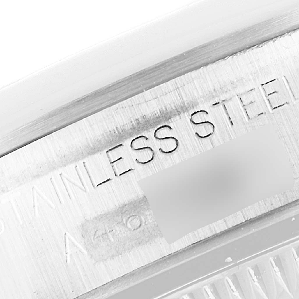 This image shows a close-up of the stainless steel engraving on the case back of a Rolex Oyster Perpetual 76080 Women's Stainless Steel Pink Dial 76080 Women's Stainless Steel Pink Dial watch.