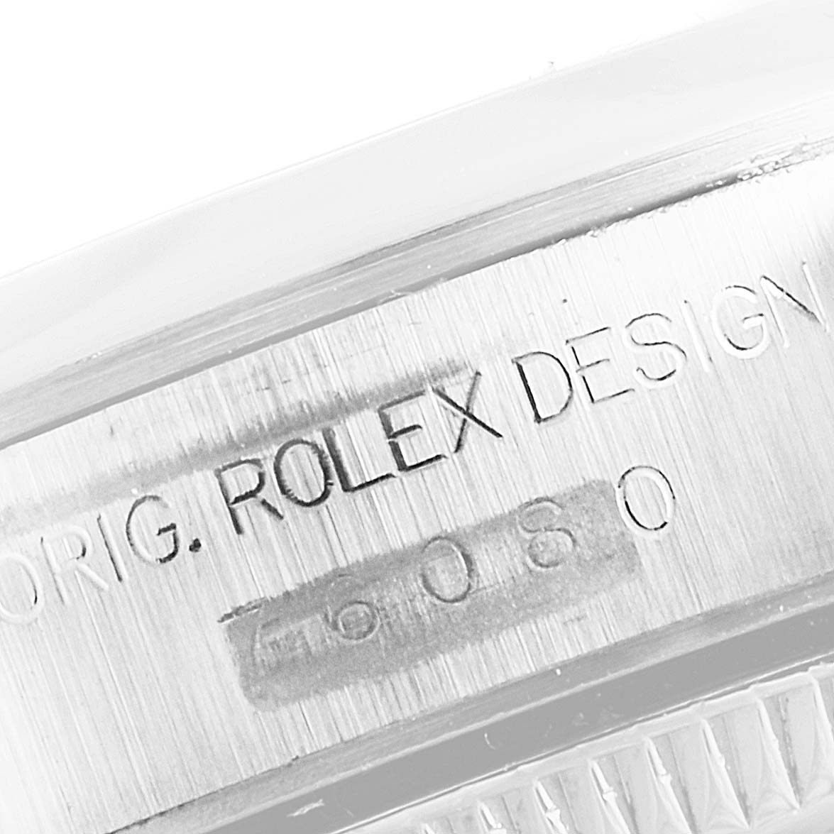 The image shows a close-up of the engraved serial number and "ORIG. ROLEX DESIGN" on the casing of a Rolex Oyster Perpetual 76080 Women's Stainless Steel Pink Dial 76080 Women's Stainless Steel Pink Dial watch.