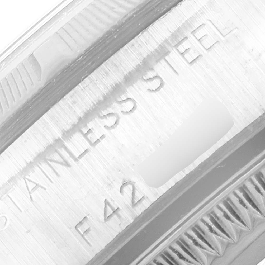 This close-up image shows the engraved text on the inner bezel of a Rolex Oyster Perpetual 76030 Women's Stainless Steel Pink Dial 76030 Women's Stainless Steel Pink Dial watch.