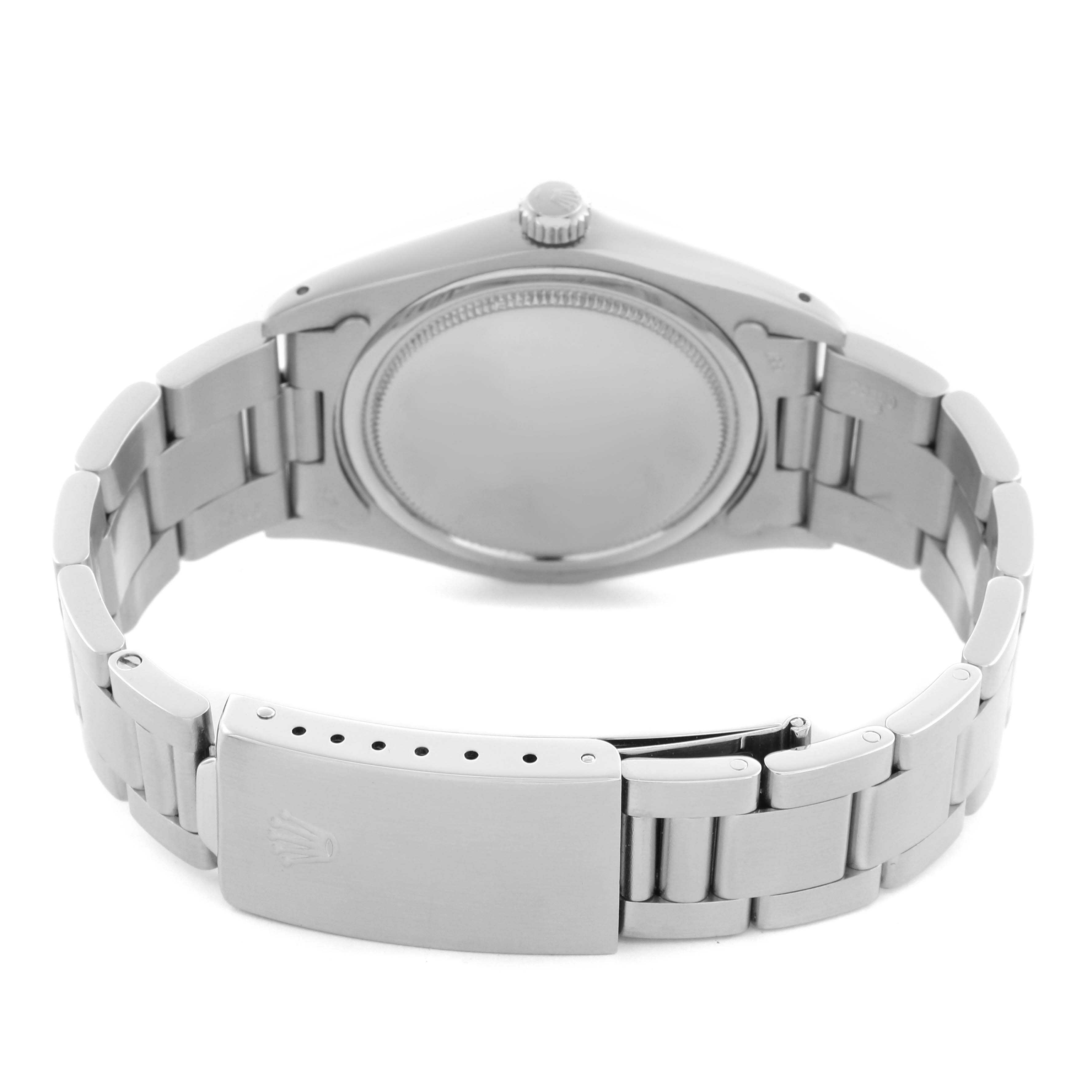 The Rolex Date watch is shown from the back, displaying the case back, bracelet, and clasp with the logo.