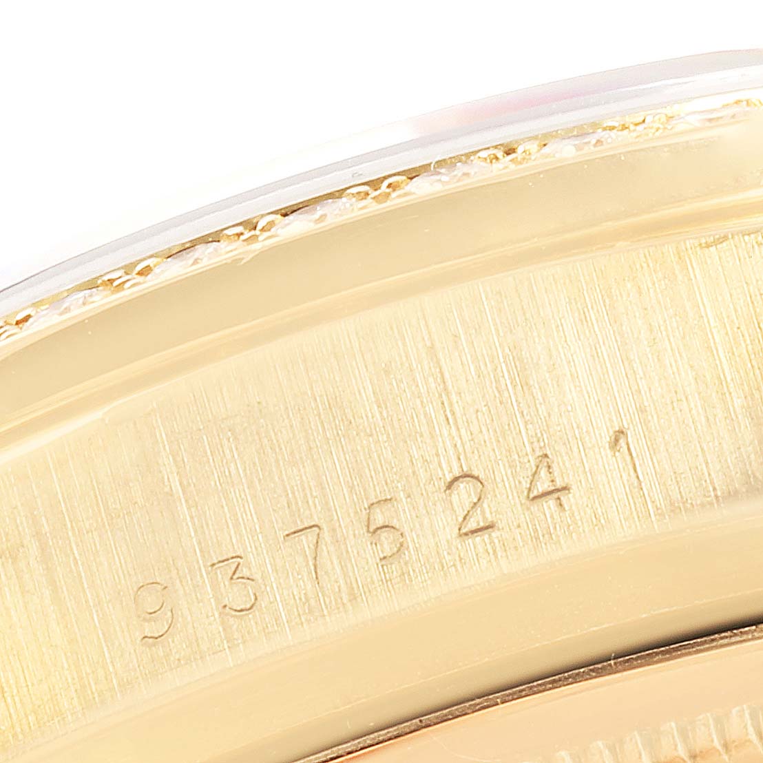 This close-up image shows the serial number engraved on the gold case of a Rolex President 18038 Men's Yellow Gold Champagne Dial 18038 Men's Yellow Gold Champagne Dial model watch.