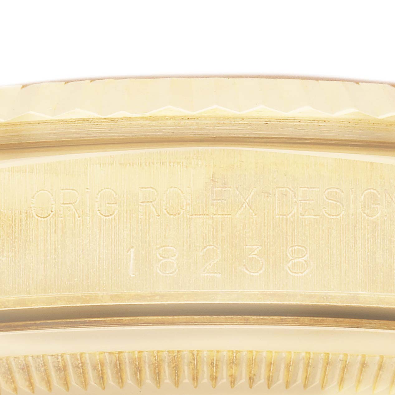 The image shows a close-up of the side engraving on the Rolex President 18238 Men's Yellow Gold Champagne Dial 18238 Men's Yellow Gold Champagne Dial model watch bezel, displaying "ORIG ROLEX DESIGN" and a model number.