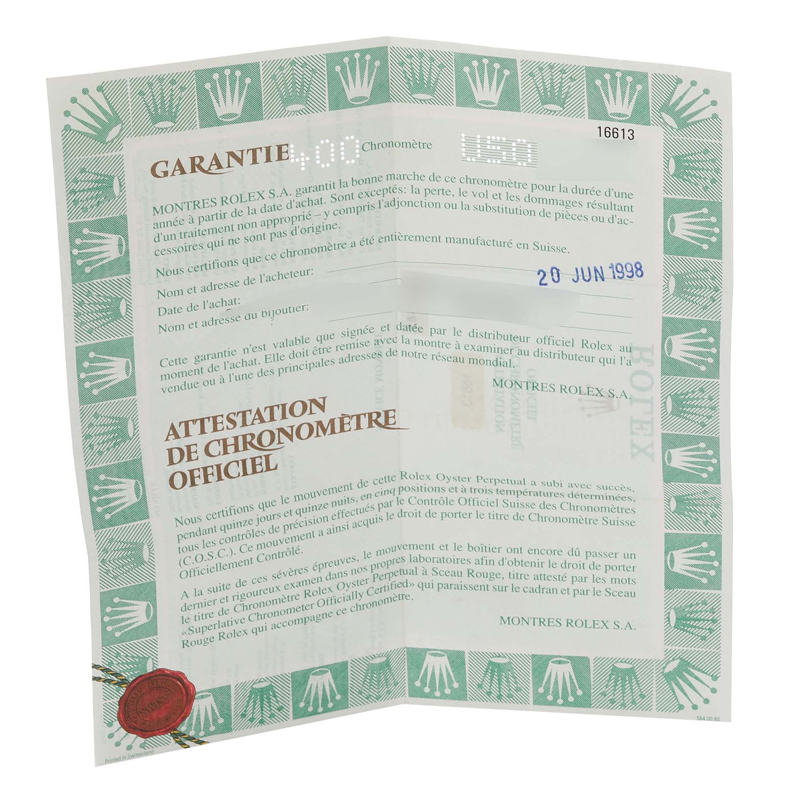 The image shows a flat lay of a Rolex Submariner 16613 Men
s Steel and Gold (two tone) Blue Dial 16613 Men
s Steel and Gold (two tone) Blue Dial warranty certificate with green borders and text details.