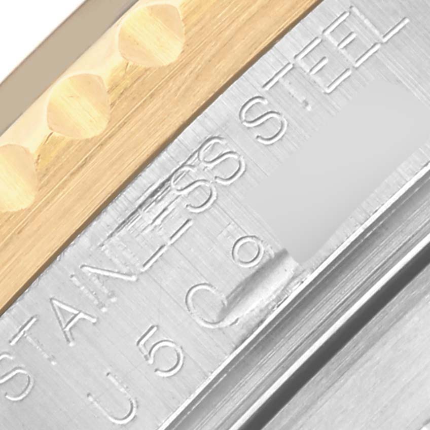 The image shows a close-up of the bezel and engraved text on the Rolex Submariner 16613 Men
s Steel and Gold (two tone) Blue Dial 16613 Men
s Steel and Gold (two tone) Blue Dial
s stainless steel case.