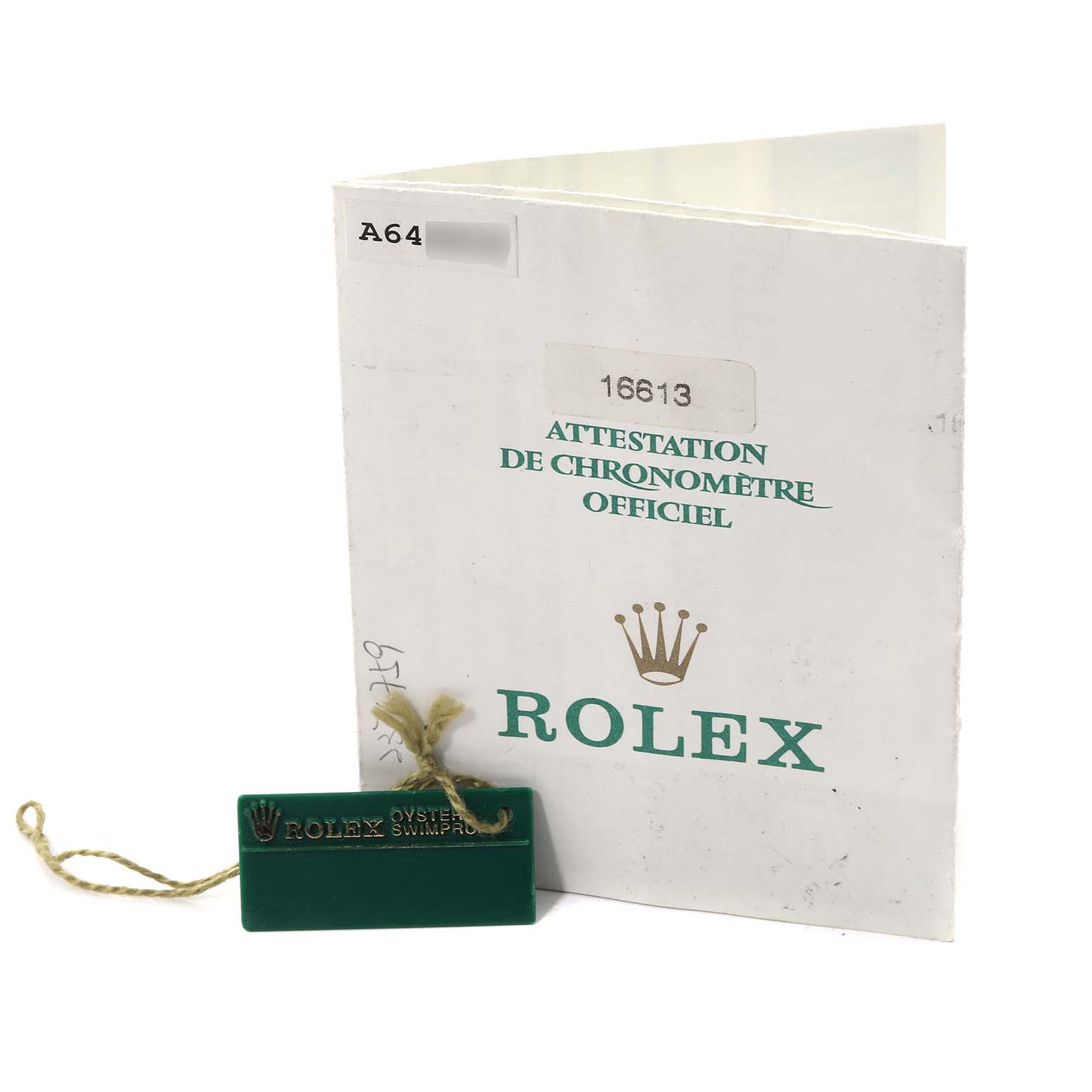 The image shows a certification booklet and a green tag for the Rolex Submariner 16613 Men's Steel and Gold (two tone) Blue Dial 16613 Men's Steel and Gold (two tone) Blue Dial model.