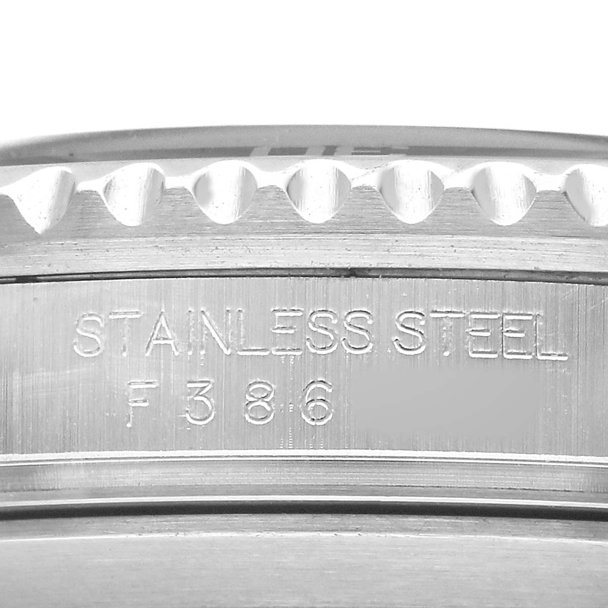 The image shows a close-up of the side of the Rolex Submariner 16610 T Men's Stainless Steel Black Dial's case, highlighting the stainless steel text engraving.