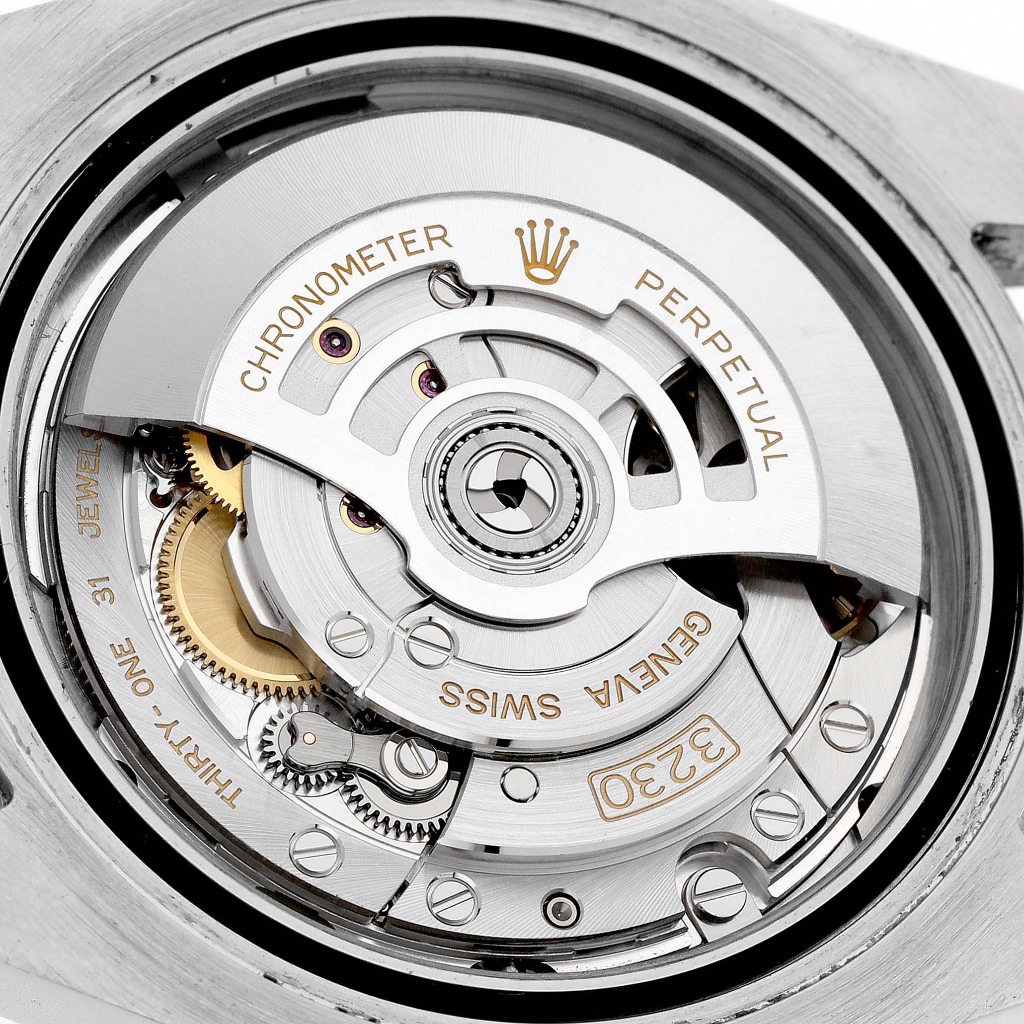 The image shows the inner mechanical movement of a Rolex Submariner M124060-0001 Men's Stainless Steel Black Dial, highlighting its gears and rotor from a top-down angle.
