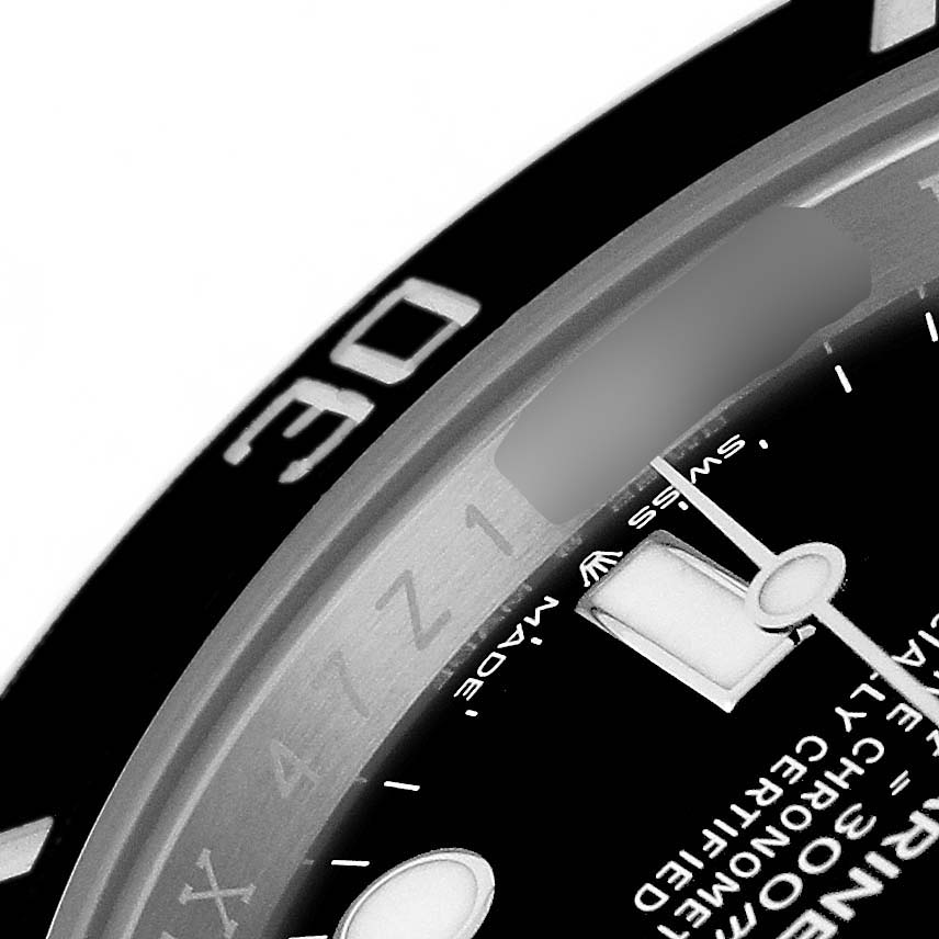 This close-up view of the Rolex Submariner M124060-0001 Men's Stainless Steel Black Dial shows part of the bezel, dial, and minute hand.