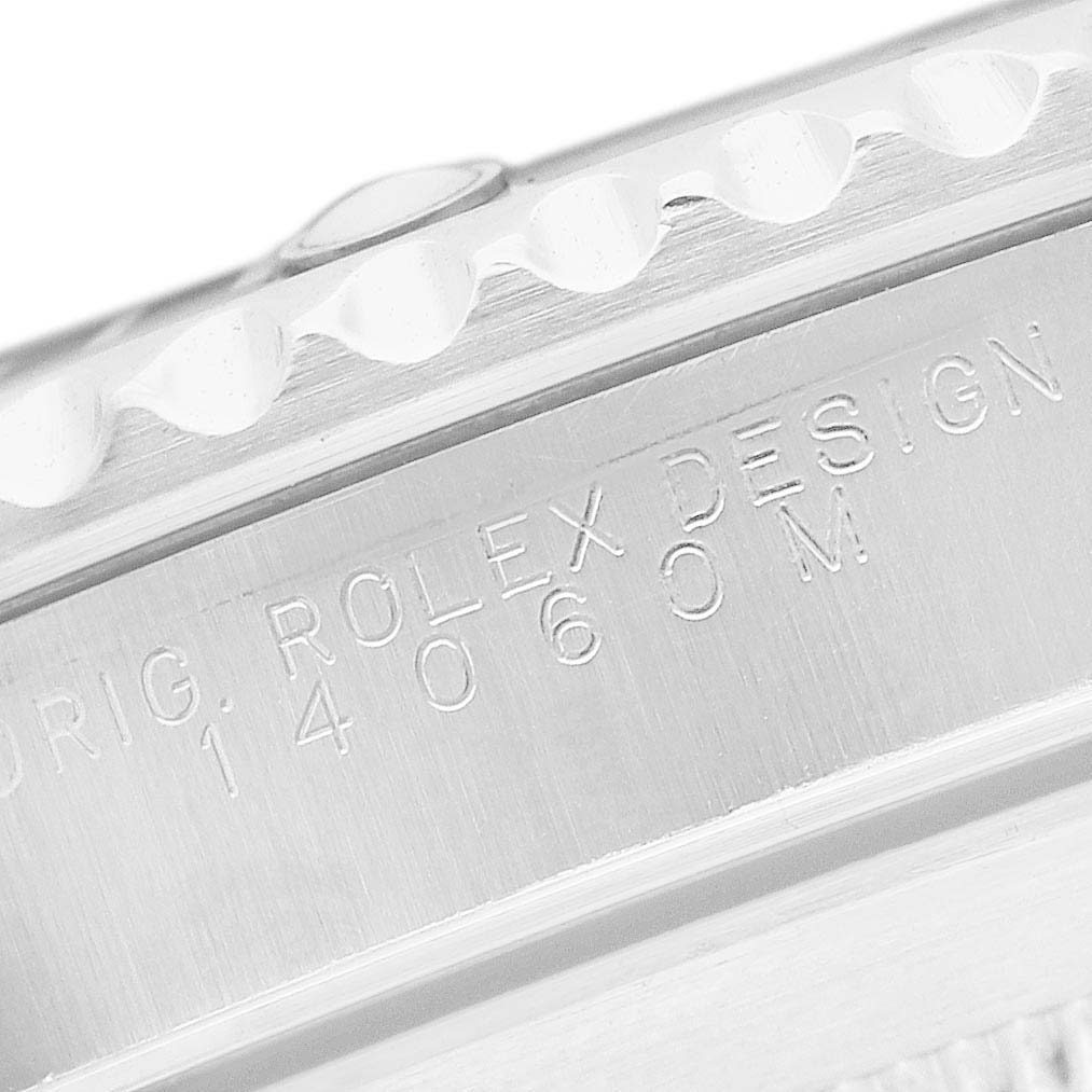 The image shows a close-up of the Rolex Submariner 14060M Men's Stainless Steel Black Dial's case side, featuring its engraved model number and design details.