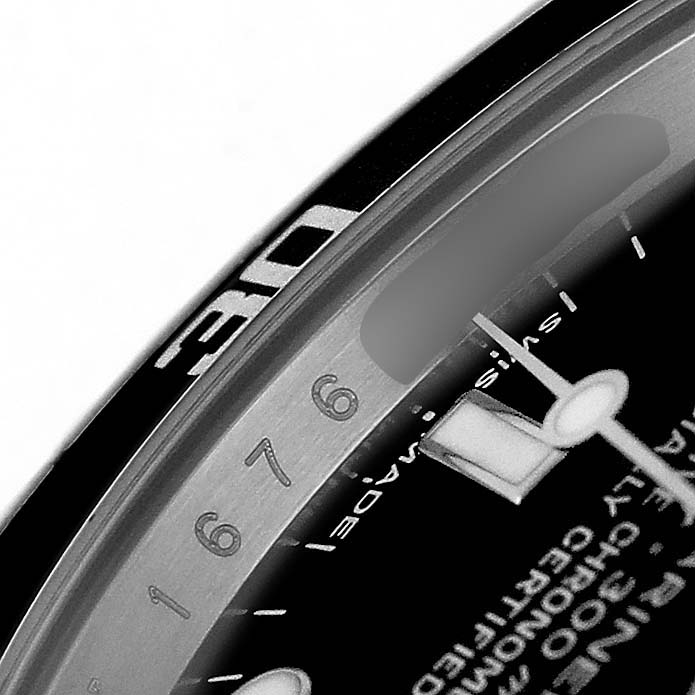 The image shows a close-up of the dial and bezel edge of a Rolex Submariner 14060M Men's Stainless Steel Black Dial watch, highlighting the numerals and markers.