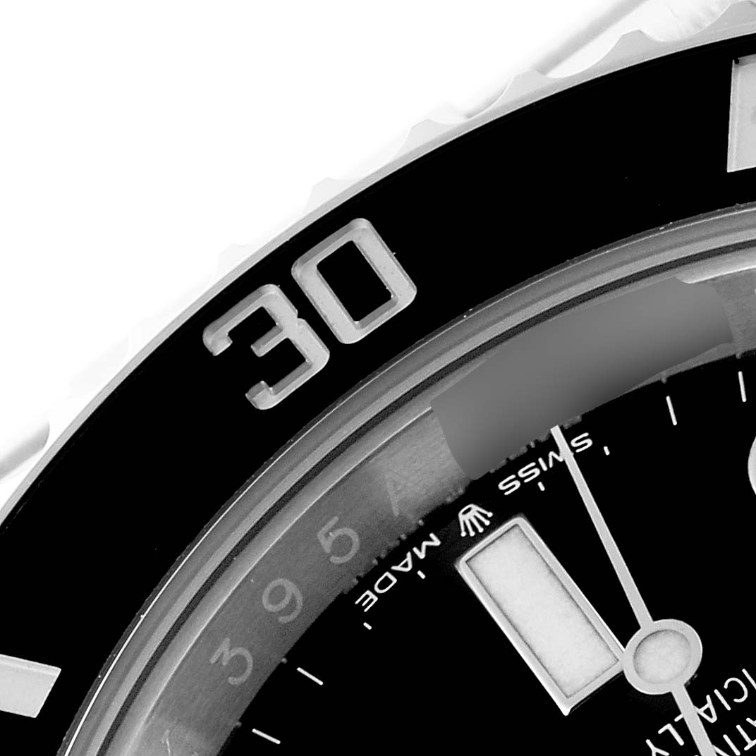 This image shows a close-up of the bezel and part of the dial of a Rolex Submariner 124060 Men
s Stainless Steel Black Dial 124060 Men
s Stainless Steel Black Dial watch.