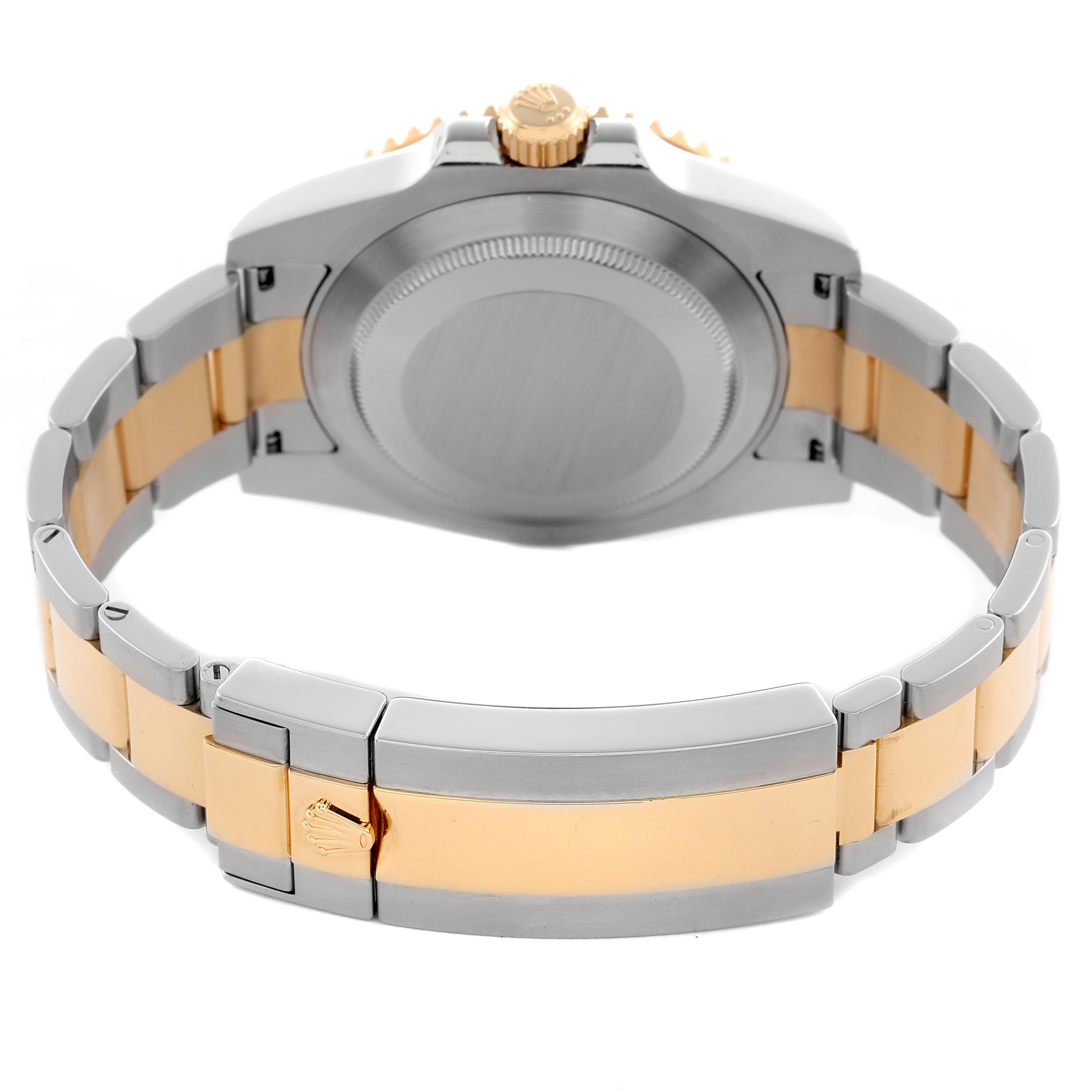 The Rolex Submariner 116613 Men
s Steel and Gold (two tone) Blue Dial 116613 Men
s Steel and Gold (two tone) Blue Dial is shown from the back, highlighting the case back, bracelet, and clasp in a two-tone design.