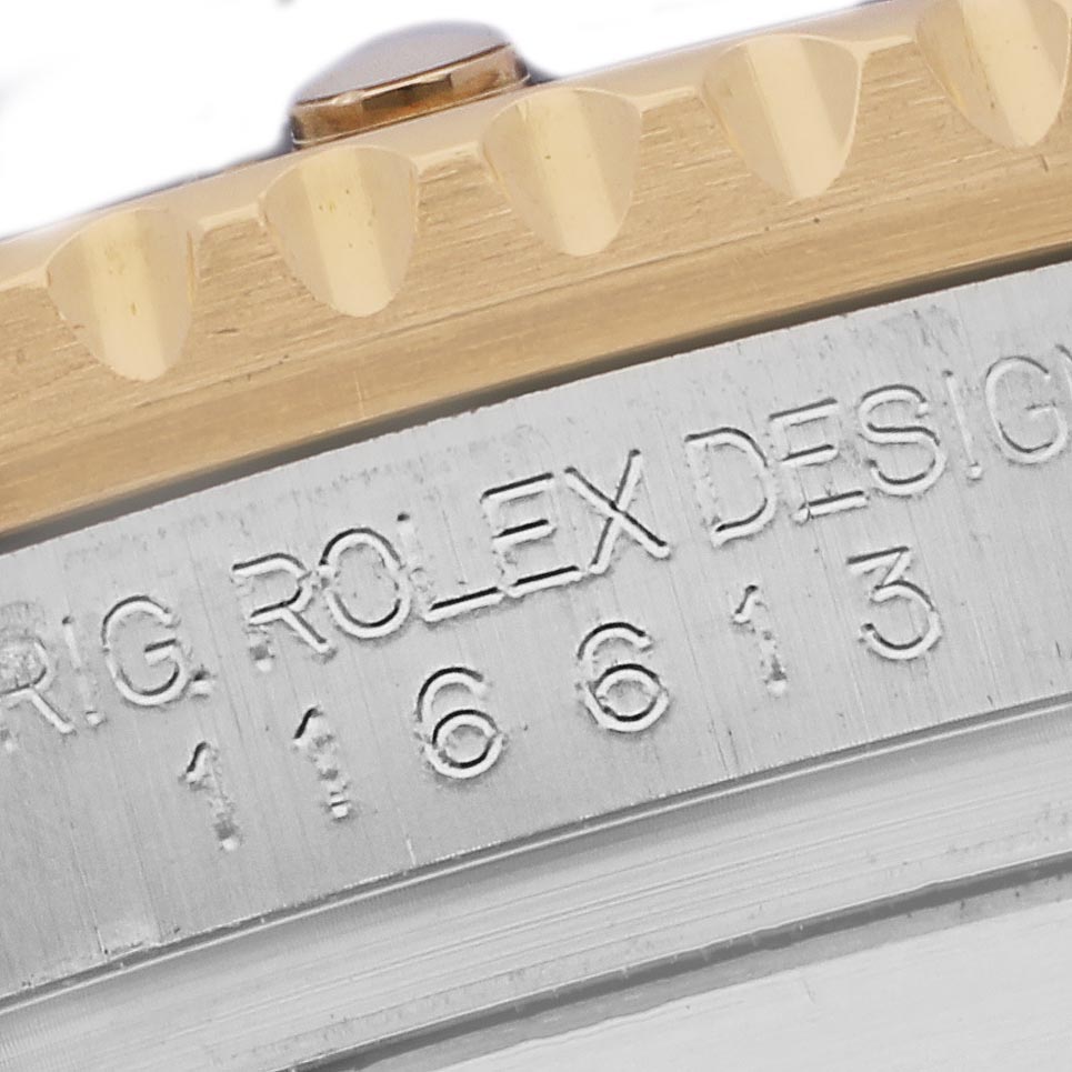 The image shows a close-up of the Rolex Submariner 116613 Men
s Steel and Gold (two tone) Blue Dial 116613 Men
s Steel and Gold (two tone) Blue Dial
s case, highlighting the serial number and part of the bezel.