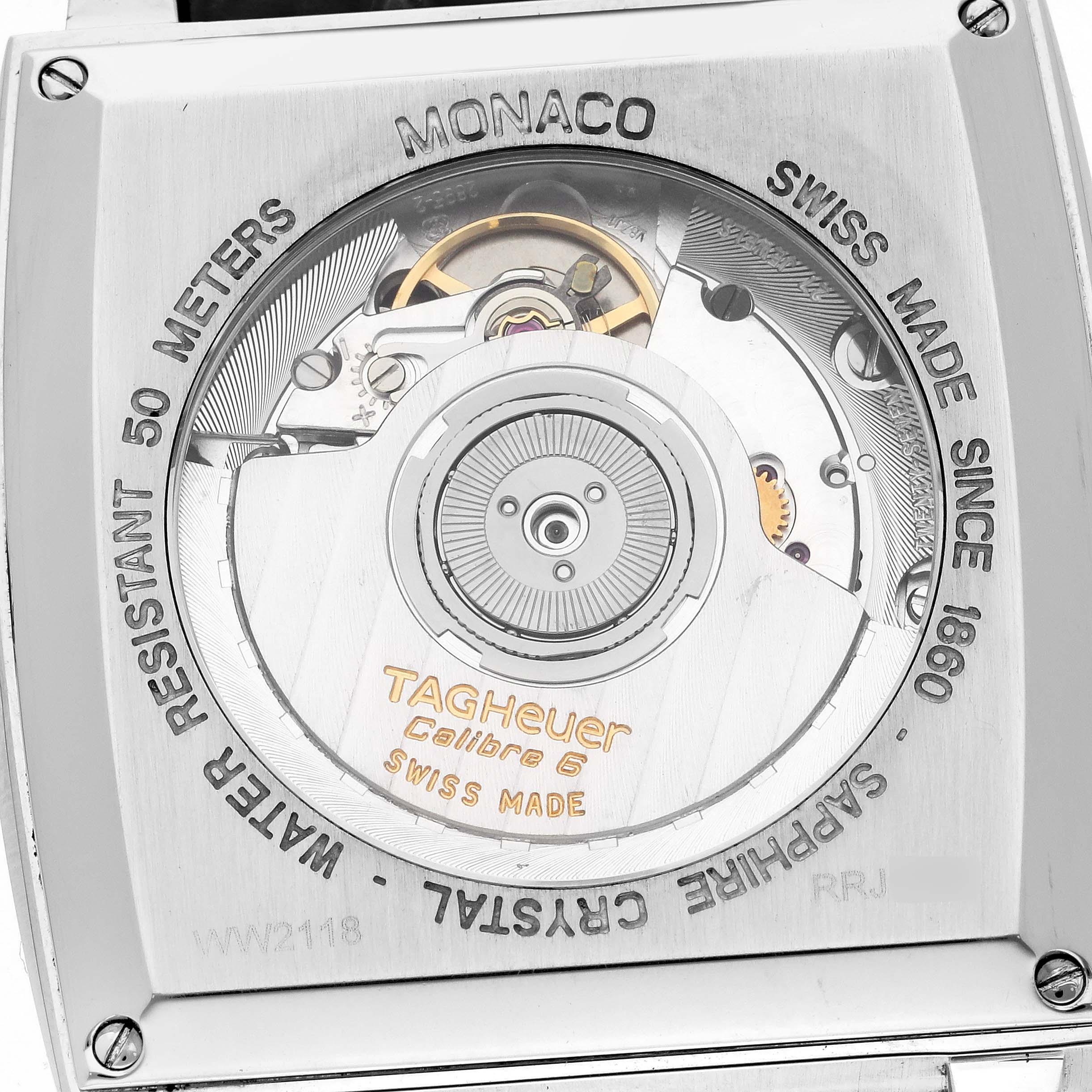 The image shows the back of a Tag Heuer Monaco 63480 Men's Stainless Steel Black Dial 63480 Men's Stainless Steel Black Dial watch, revealing its movement and "Calibre 6" engraving.