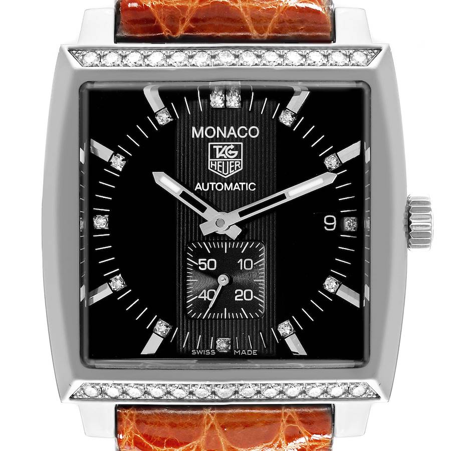 The Tag Heuer Monaco watch is shown from a front angle, displaying the dial, hands, and crown.