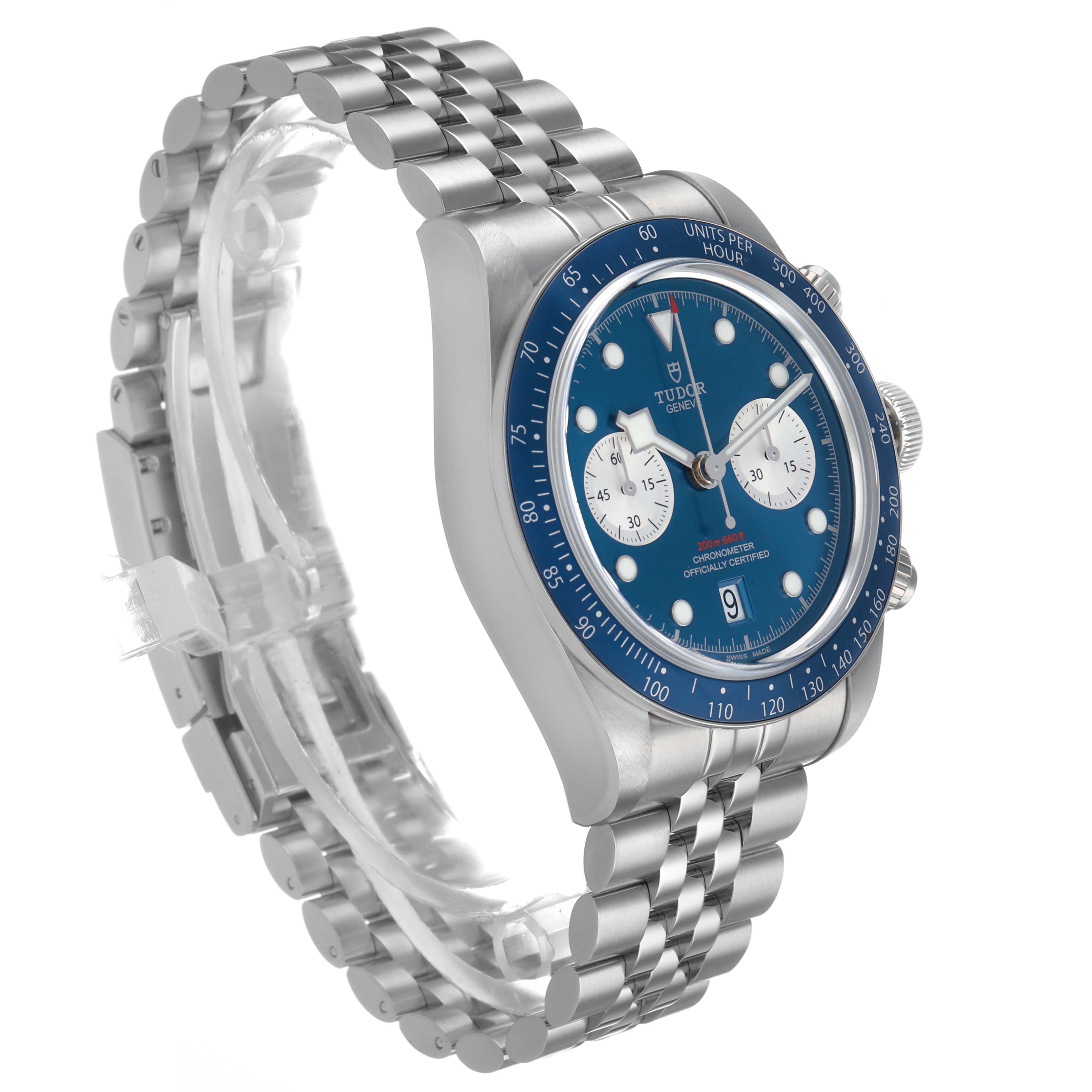 The Tudor Heritage Chrono M79360B-0002 Men's Stainless Steel Blue Dial watch is shown at a three-quarter angle, displaying the dial, bezel, and bracelet.