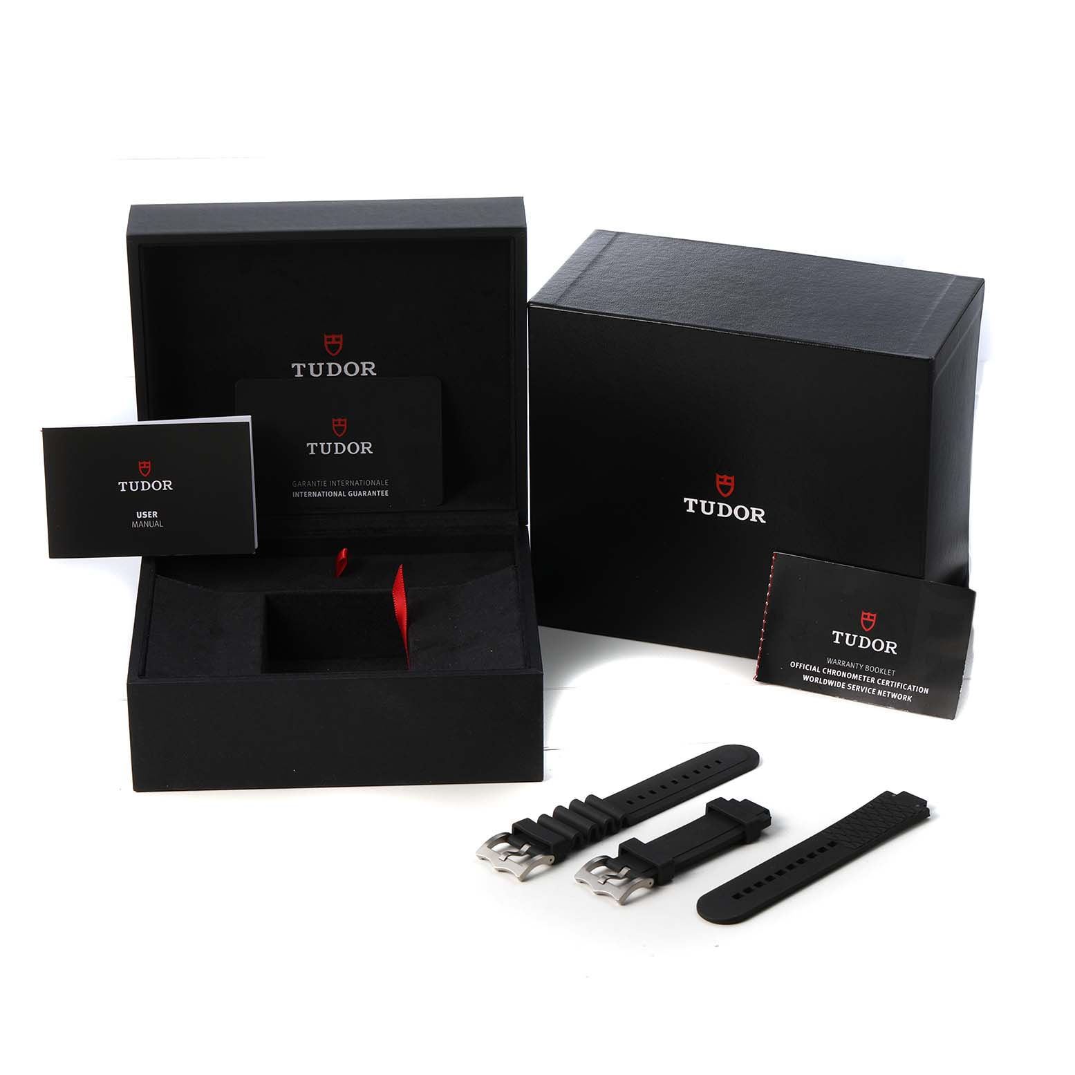 The image shows a Tudor Pelagos 25600TN Men's Titanium Black Dial watch box with black rubber straps, manuals, and warranty cards displayed from a top angle.