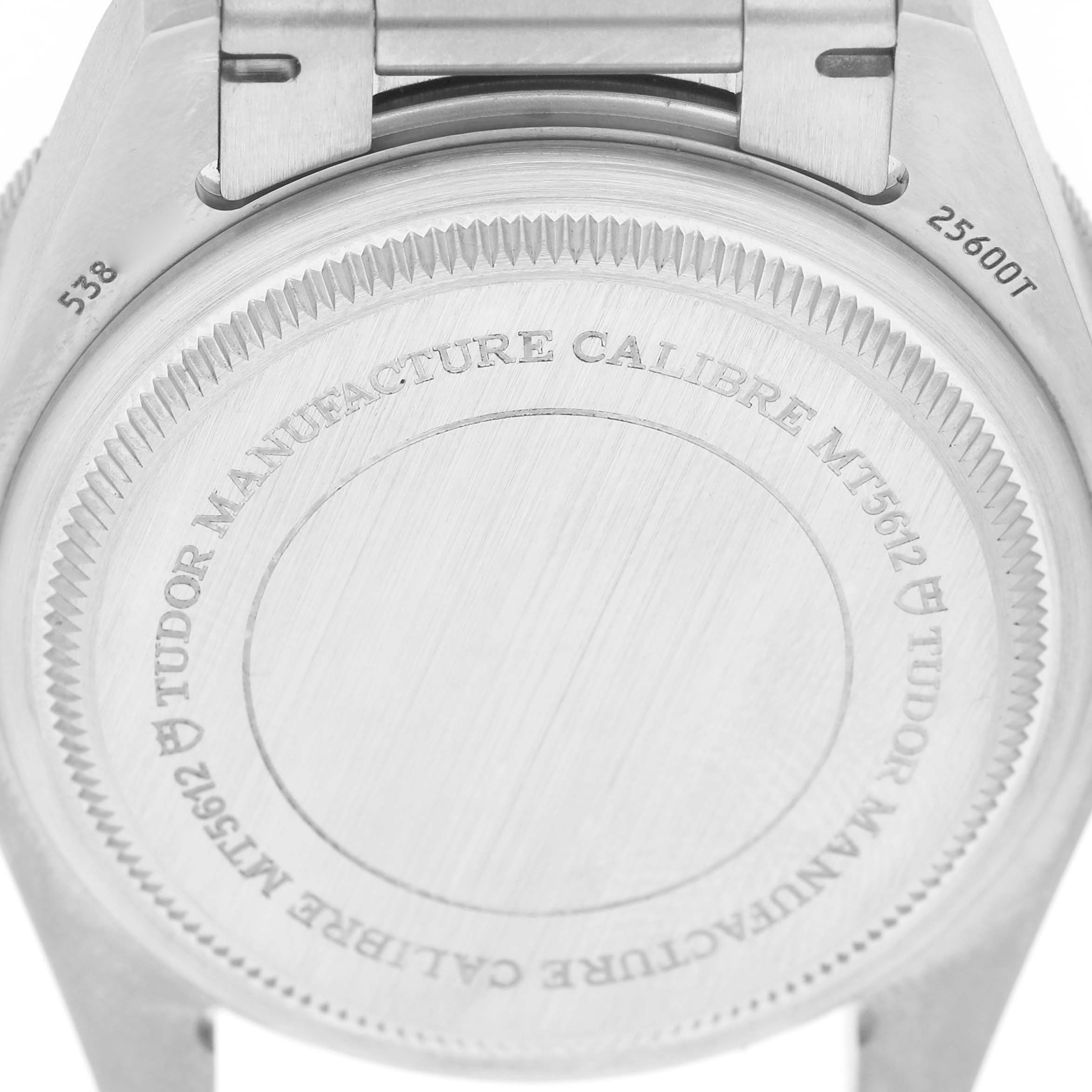 The image shows the back case of the Tudor Heritage Chrono 25600TN Men's Titanium Black Dial watch, displaying engraved details and part of the clasp.