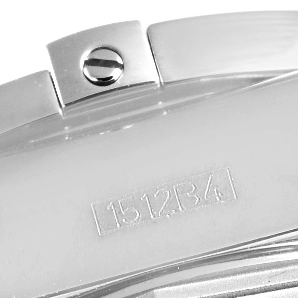 The image shows a close-up of the clasp mechanism of a Breitling Chronomat AB0140 Men
s Stainless Steel Black Dial AB0140 Men
s Stainless Steel Black Dial watch, focusing on a screw and a serial number.