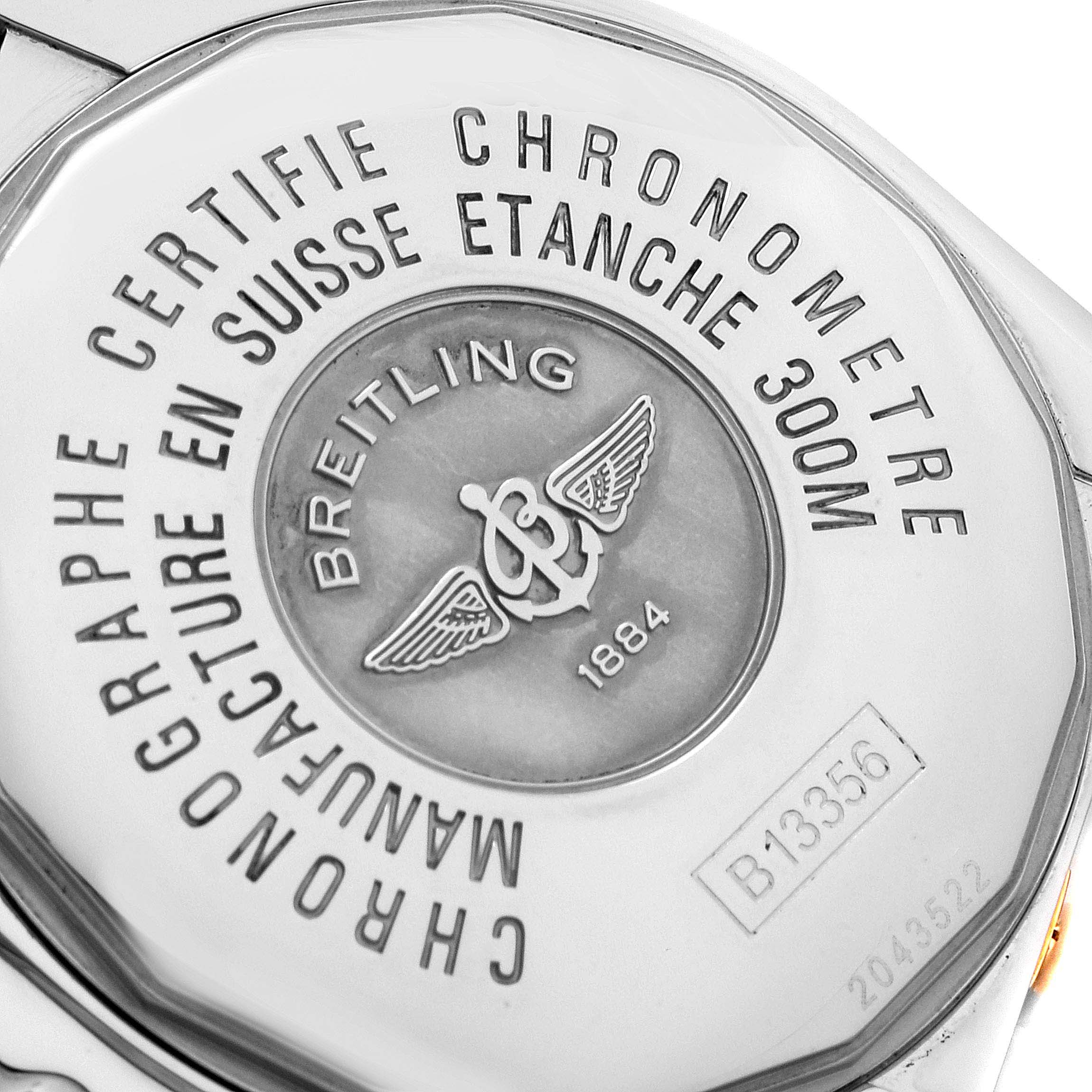 This image shows the back case of a Breitling Chronomat B13356 Men
s Steel and Gold (two tone) Black Dial B13356 Men
s Steel and Gold (two tone) Black Dial watch, highlighting the brand logo and model-specific engravings.