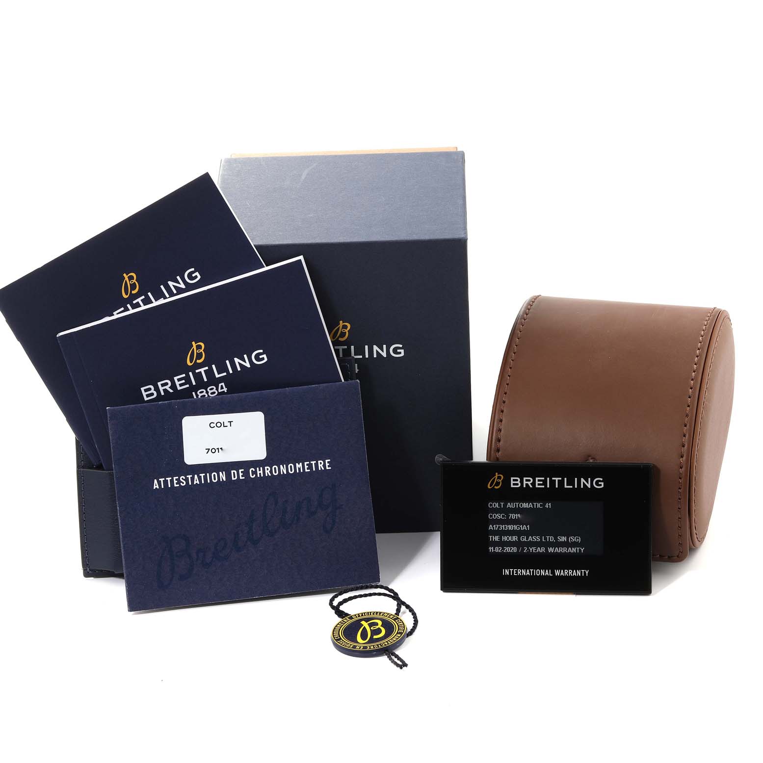 The image shows the Breitling Colt A17313 Men's Stainless Steel Silver Dial A17313 Men's Stainless Steel Silver Dial watch accessories including manuals, warranty cards, a leather pouch, and a tag.