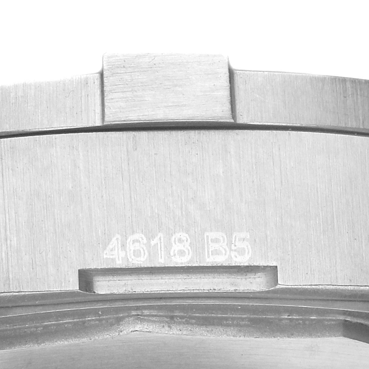 This image shows a close-up of the serial number and part of the brushed metal case of a Breitling Colt A17313 Men's Stainless Steel Silver Dial A17313 Men's Stainless Steel Silver Dial watch.