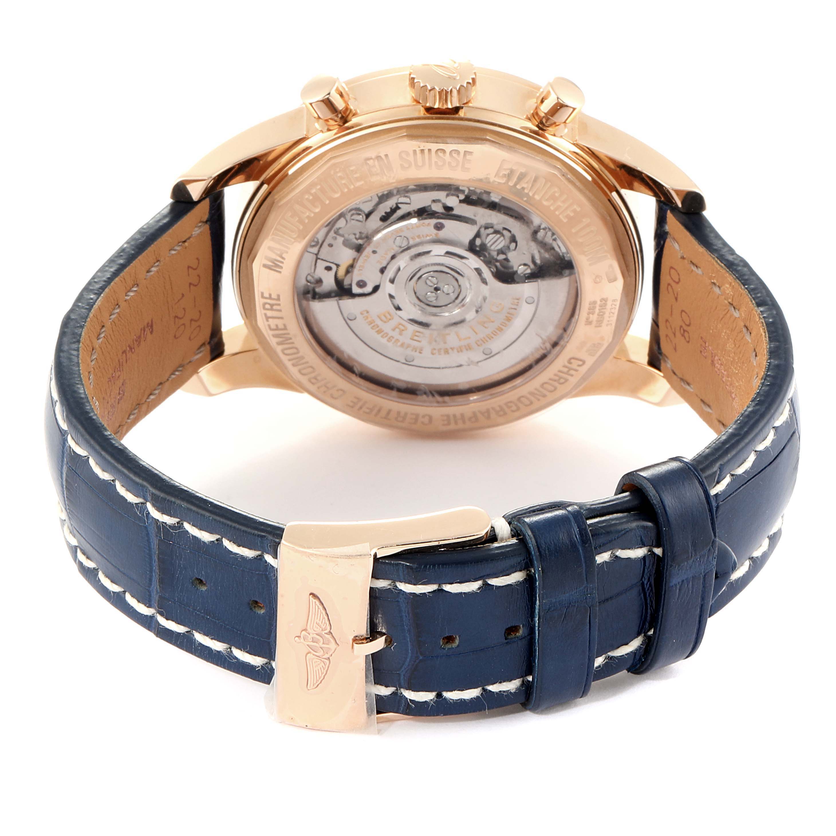 The image shows the back of the Breitling Transocean RB0152 Men's Rose Gold Silver Dial RB0152 Men's Rose Gold Silver Dial watch, highlighting the movement through the transparent case back and blue leather strap.