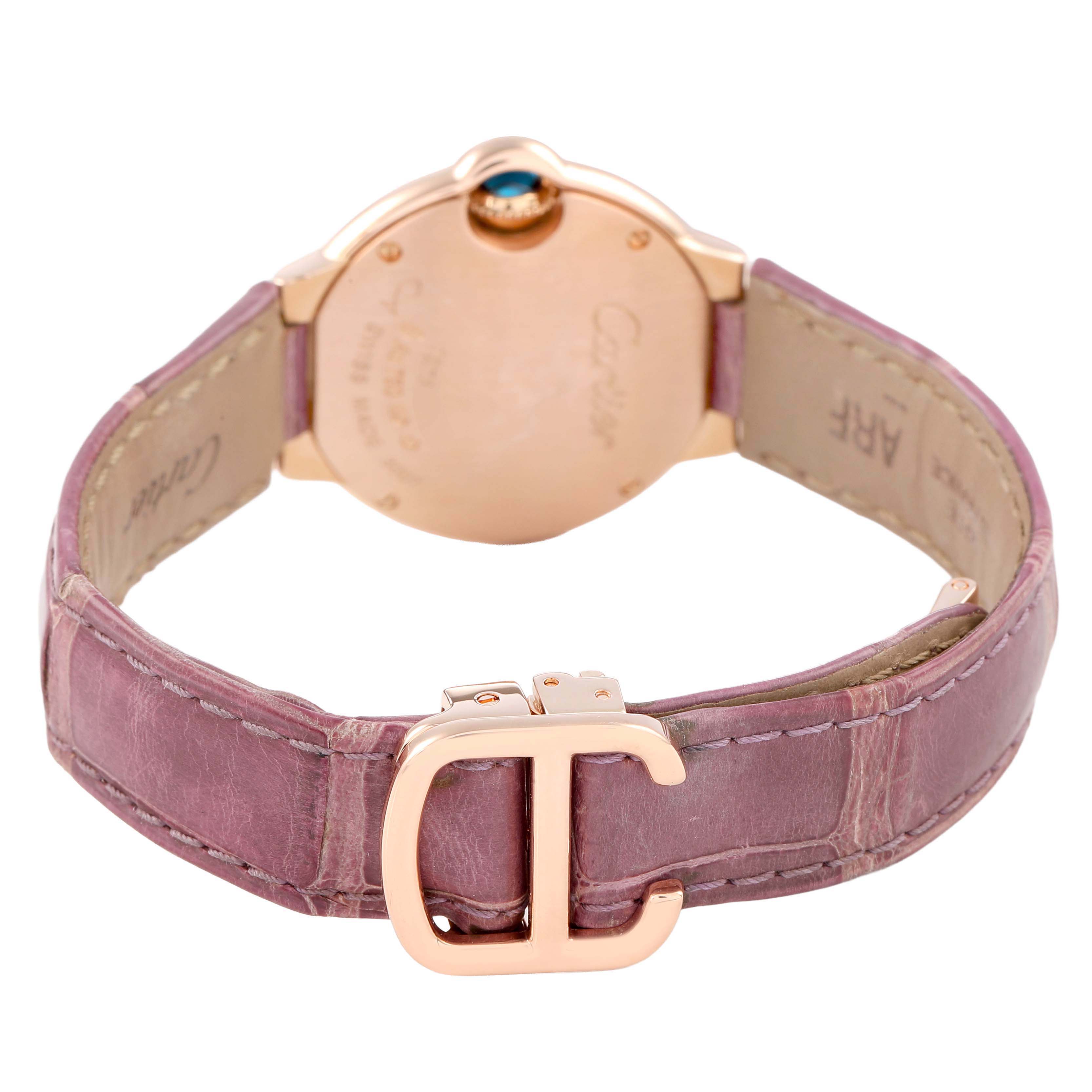 The image shows the back view of a Ballon Bleu de Cartier watch, highlighting the pink leather strap and clasp.
