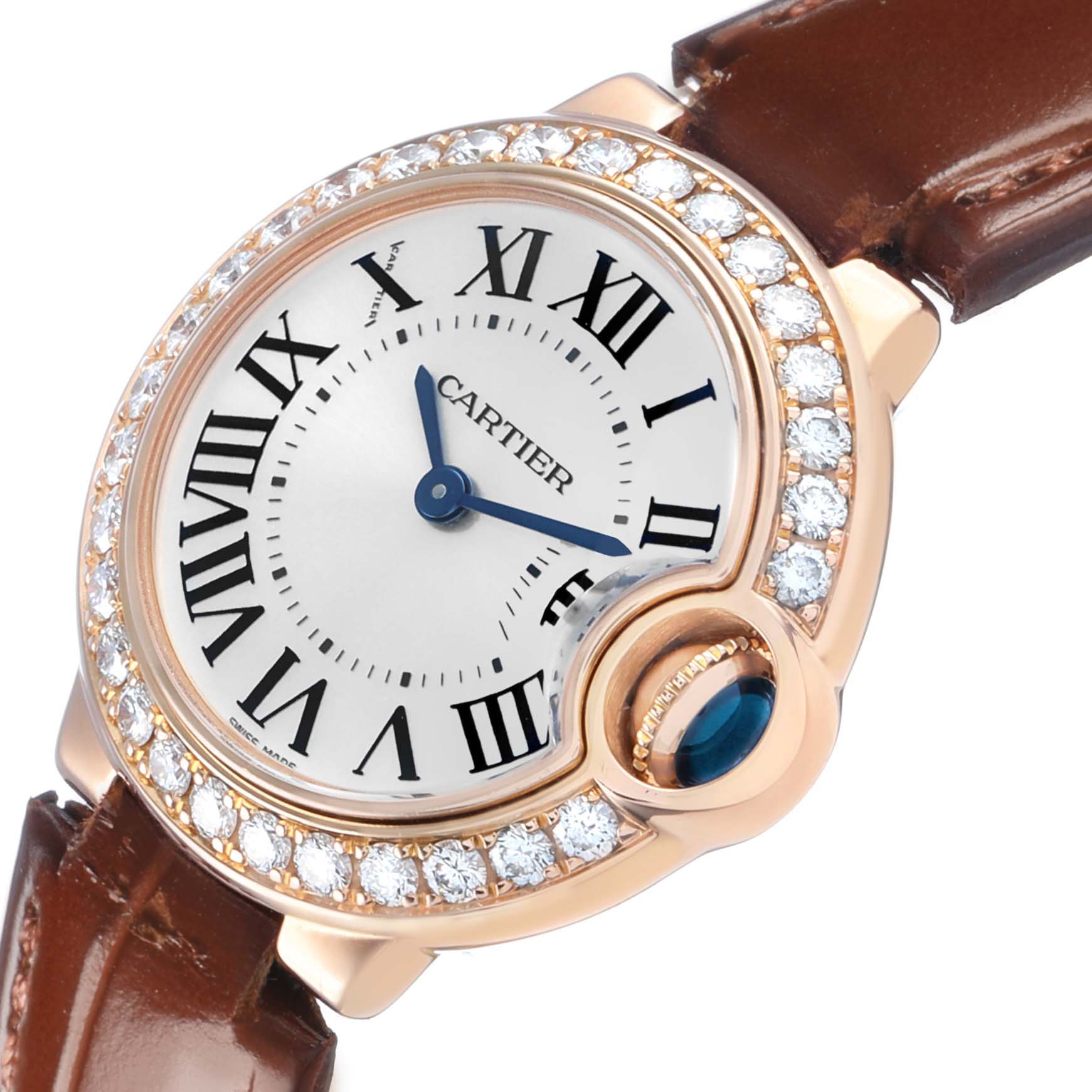 The Cartier Ballon Bleu WE900251 Women's Rose Gold Silver Dial watch is shown at an angle highlighting its diamond bezel, Roman numerals, and blue sapphire crown.