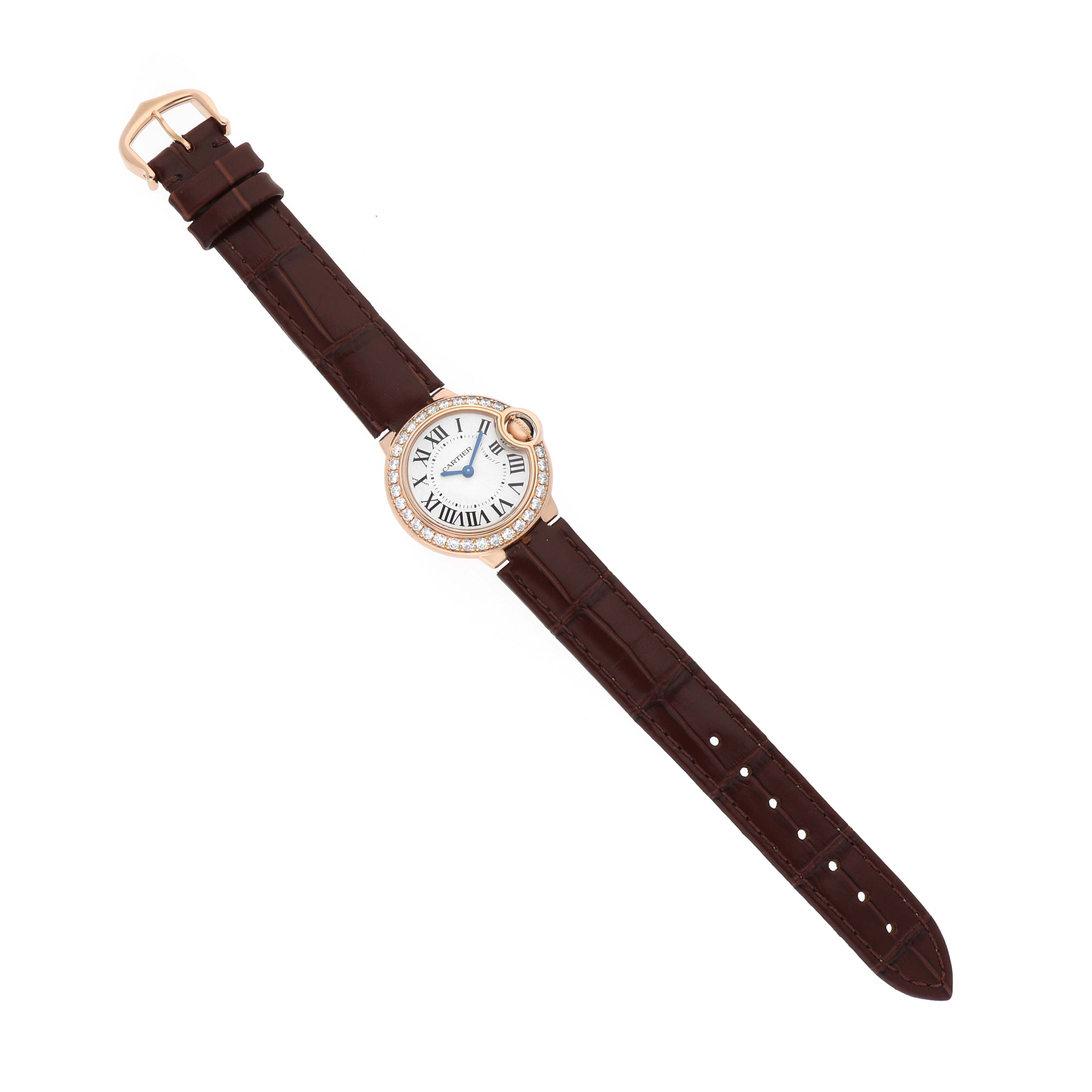 The Cartier Ballon Bleu WE900251 Women's Rose Gold Silver Dial watch is shown from a top-down angle, highlighting its round face, Roman numerals, and brown leather strap.