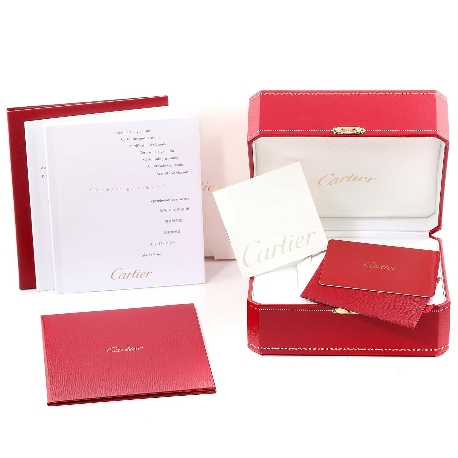 The image shows the packaging and documentation for a Cartier Ballon Bleu WE902074 Women
s Stainless Steel Silver Dial WE902074 Women
s Stainless Steel Silver Dial watch, including the red box and various booklets.