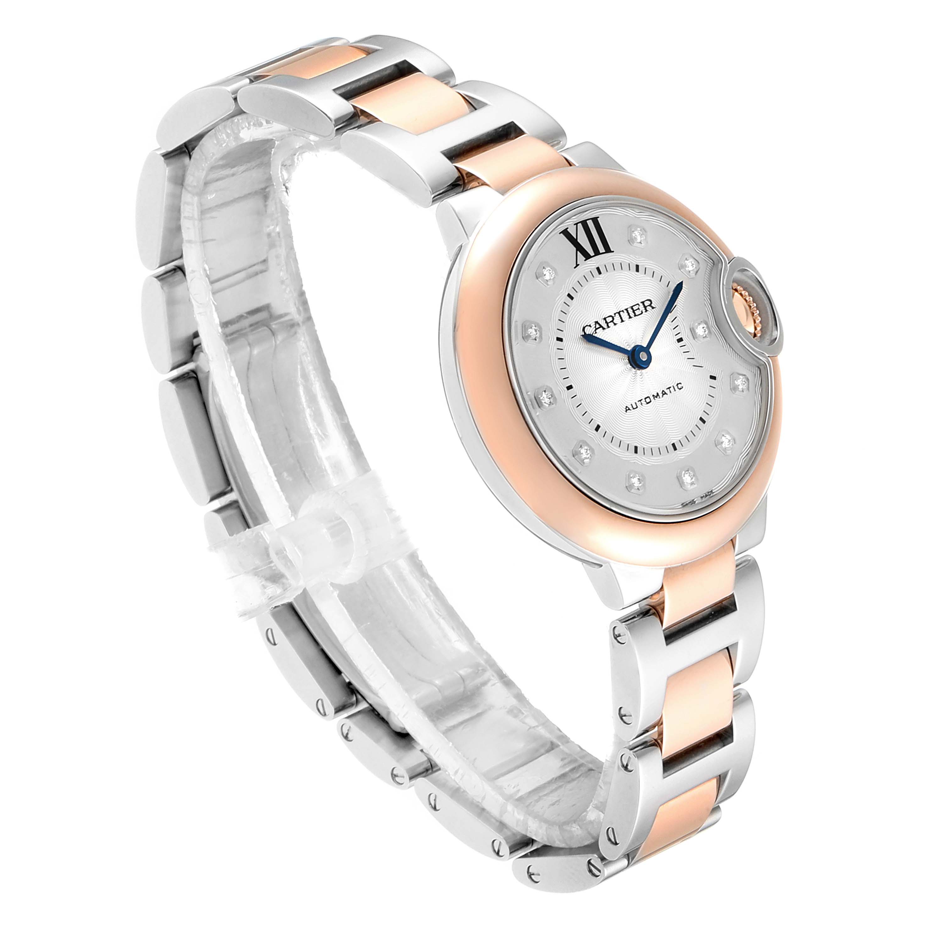 The image shows a Cartier Ballon Bleu WE902061 Women
s Steel and Gold (two tone) Silver Dial WE902061 Women
s Steel and Gold (two tone) Silver Dial watch at a tilted angle, highlighting its face and two-tone metal bracelet.